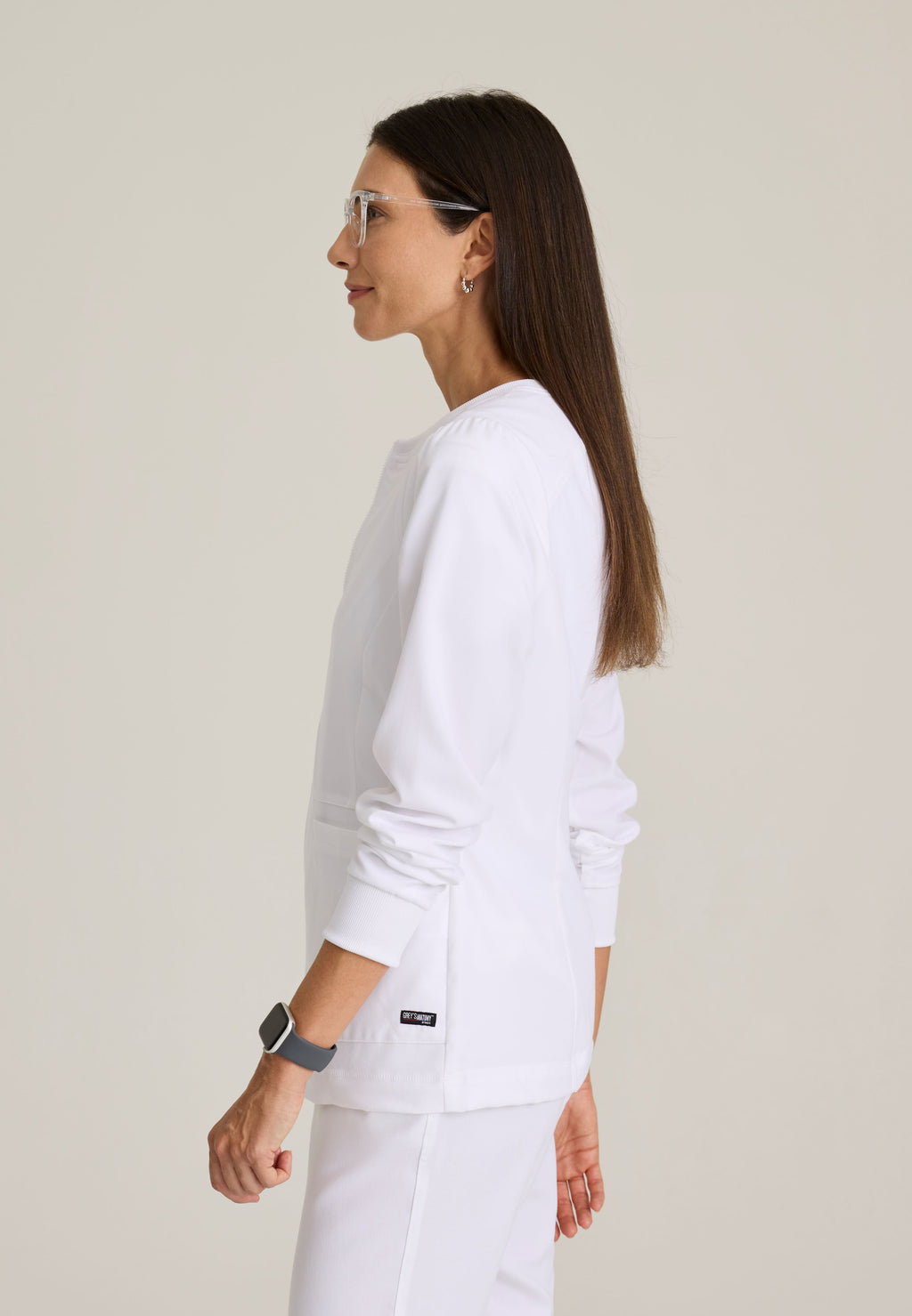Side View of the Millie 3-Pocket Crewneck Scrub Jacket in White from Grey's Anatomy™ by Barco Spandex Stretch