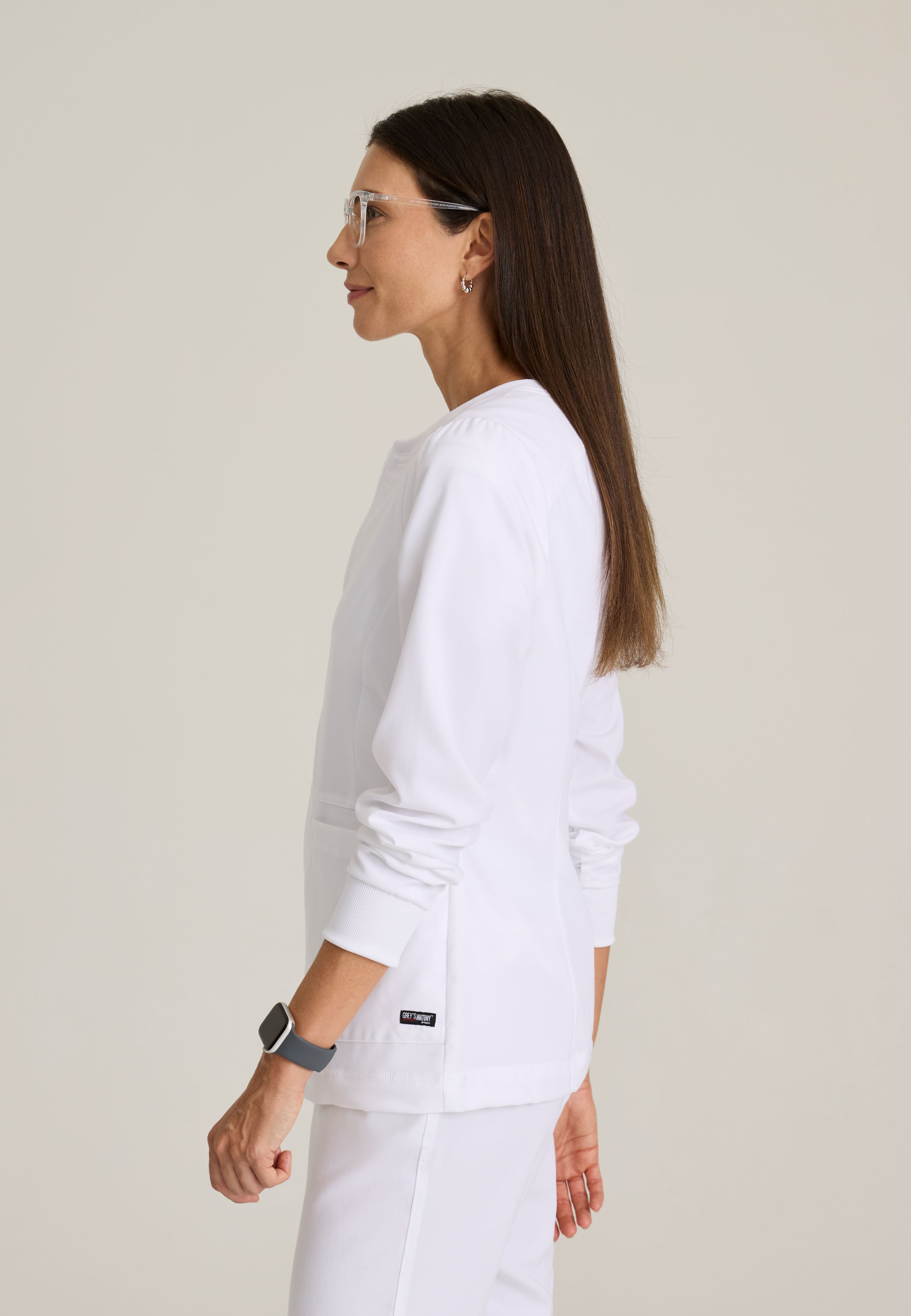 Side View of the Millie 3-Pocket Crewneck Scrub Jacket in White from Grey's Anatomy™ by Barco Spandex Stretch