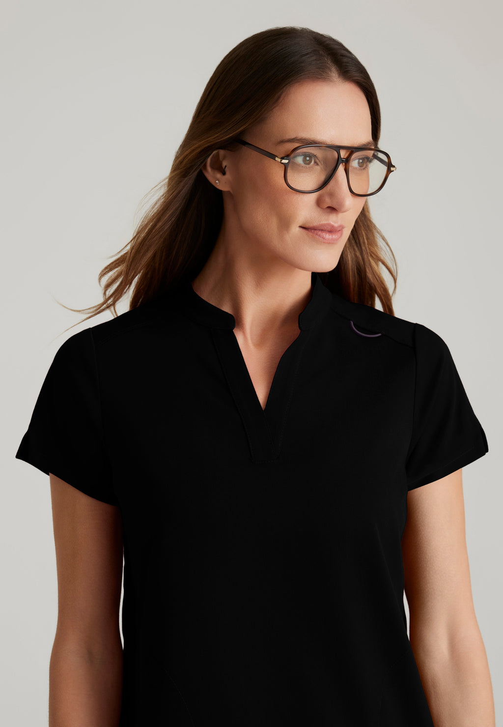 Detail Shot of the Avery 2-Pocket Banded Collar Top in Black from Grey's Anatomy™ by Barco Spandex Stretch