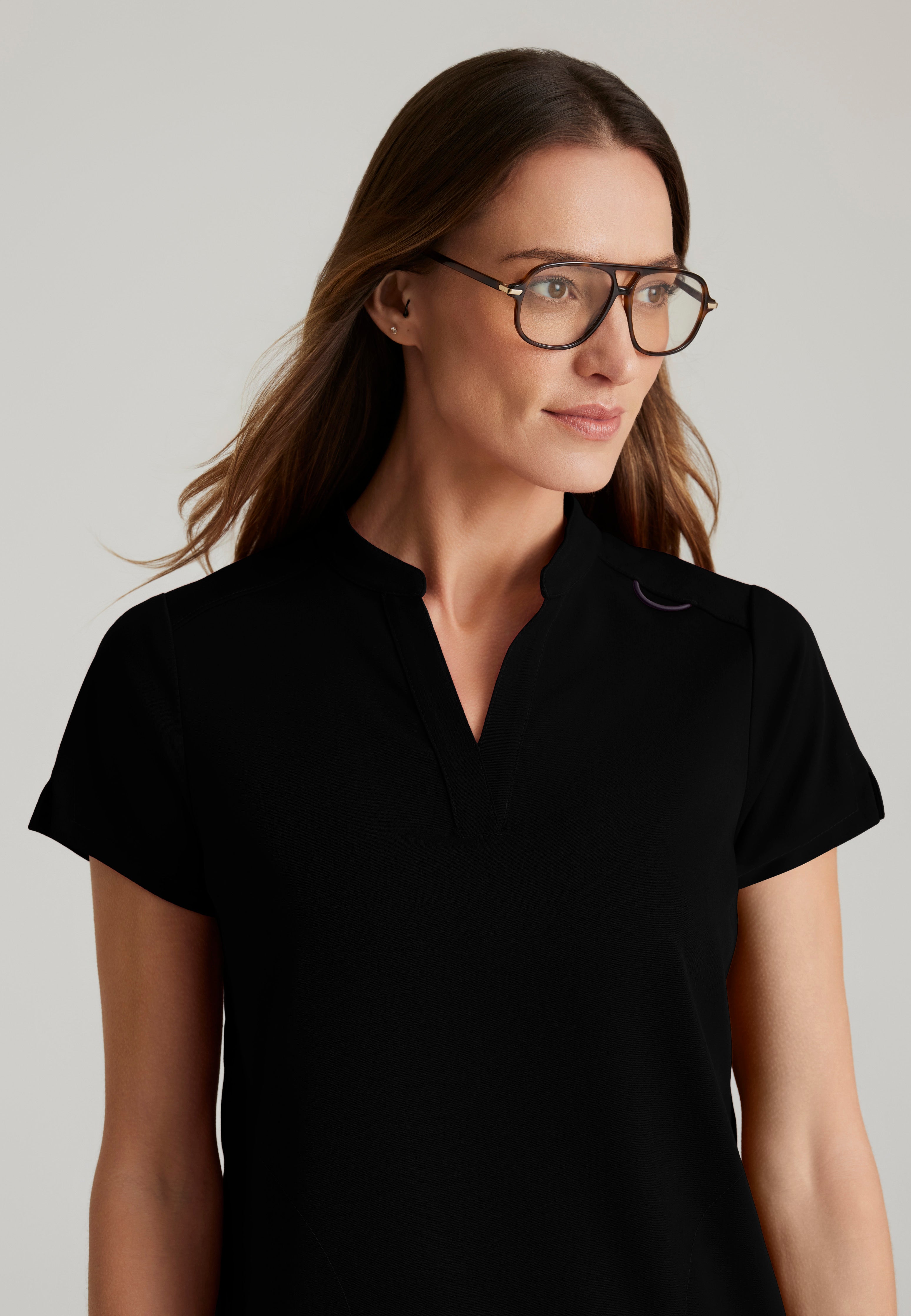Detail Shot of the Avery 2-Pocket Banded Collar Top in Black from Grey's Anatomy™ by Barco Spandex Stretch