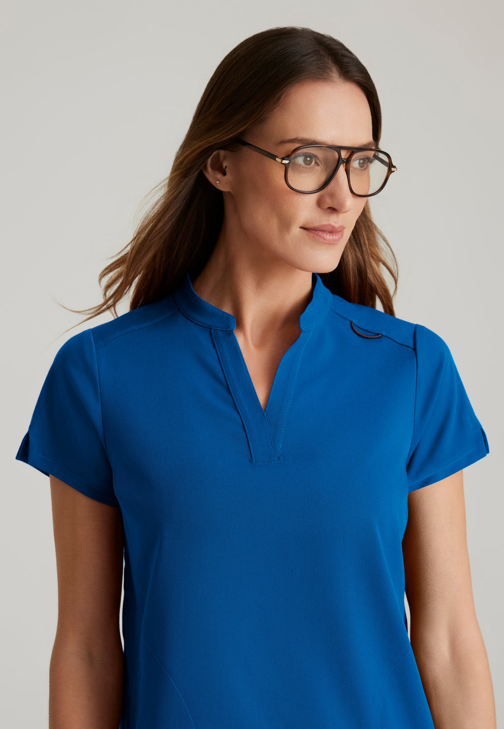 Detail Shot of the Avery 2-Pocket Banded Collar Top in New Royal from Grey's Anatomy™ by Barco Spandex Stretch