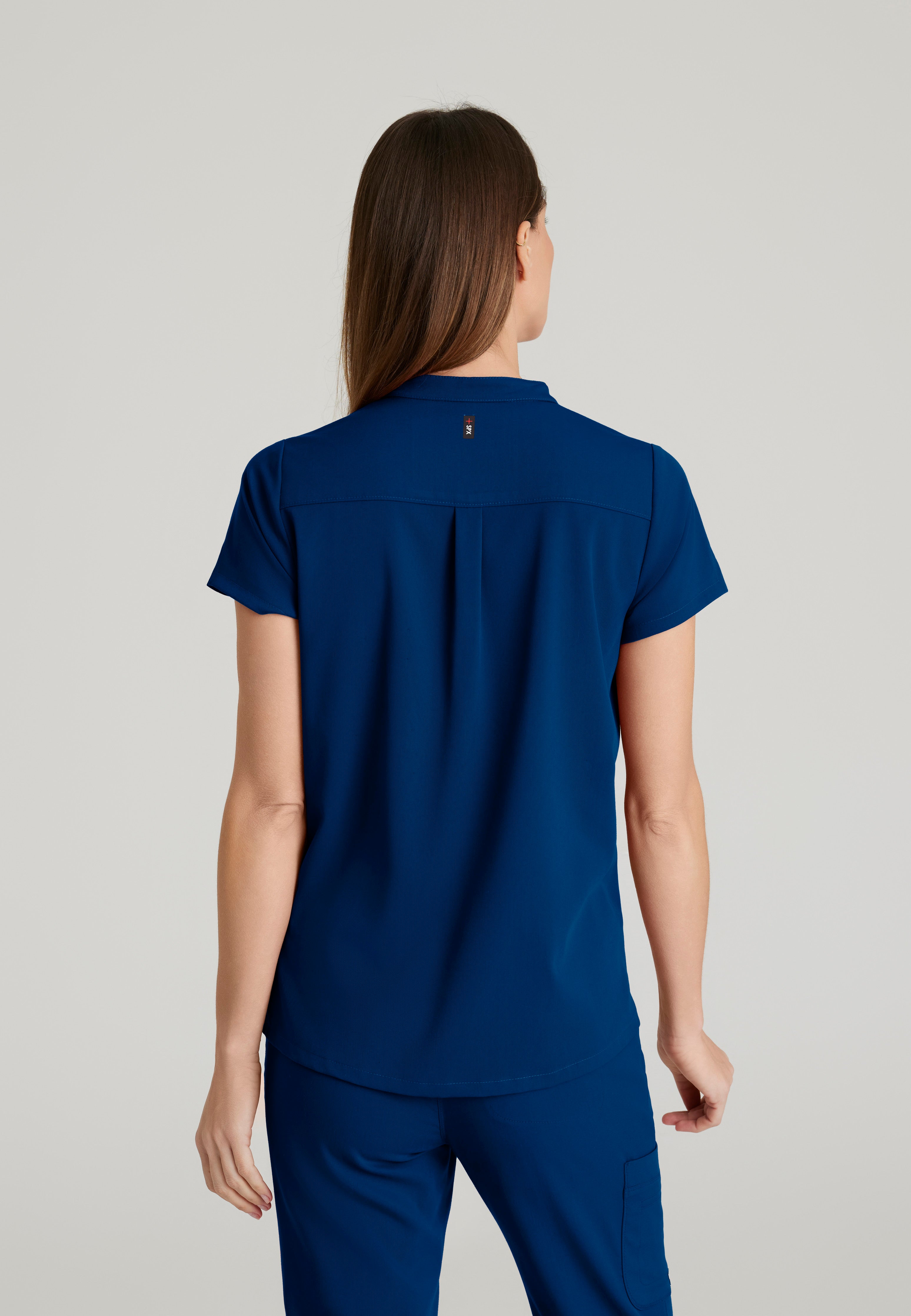 Back View of the Avery 2-Pocket Banded Collar Top in Indigo from Grey's Anatomy™ by Barco Spandex Stretch