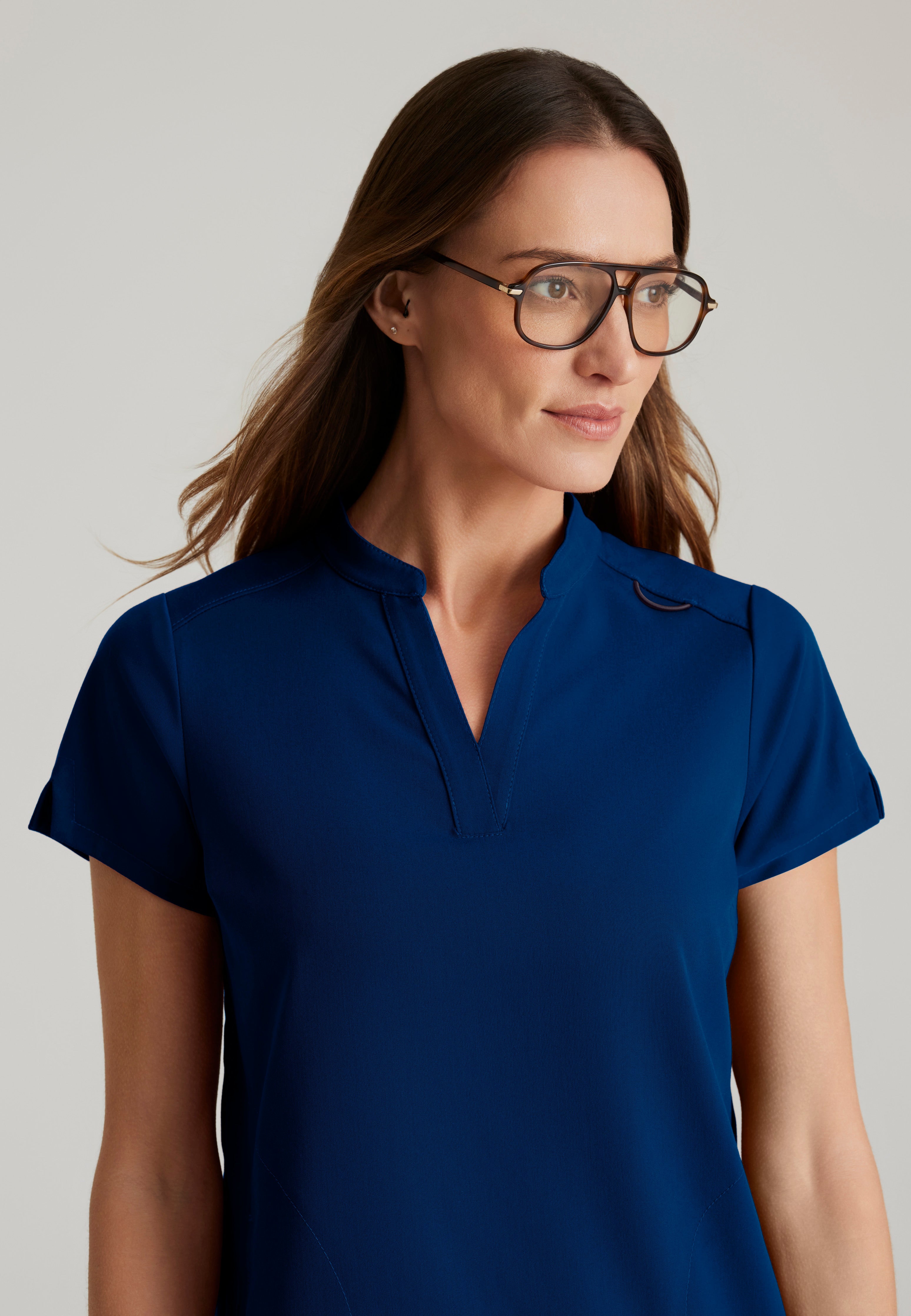 Detail Shot of the Avery 2-Pocket Banded Collar Top in Indigo from Grey's Anatomy™ by Barco Spandex Stretch