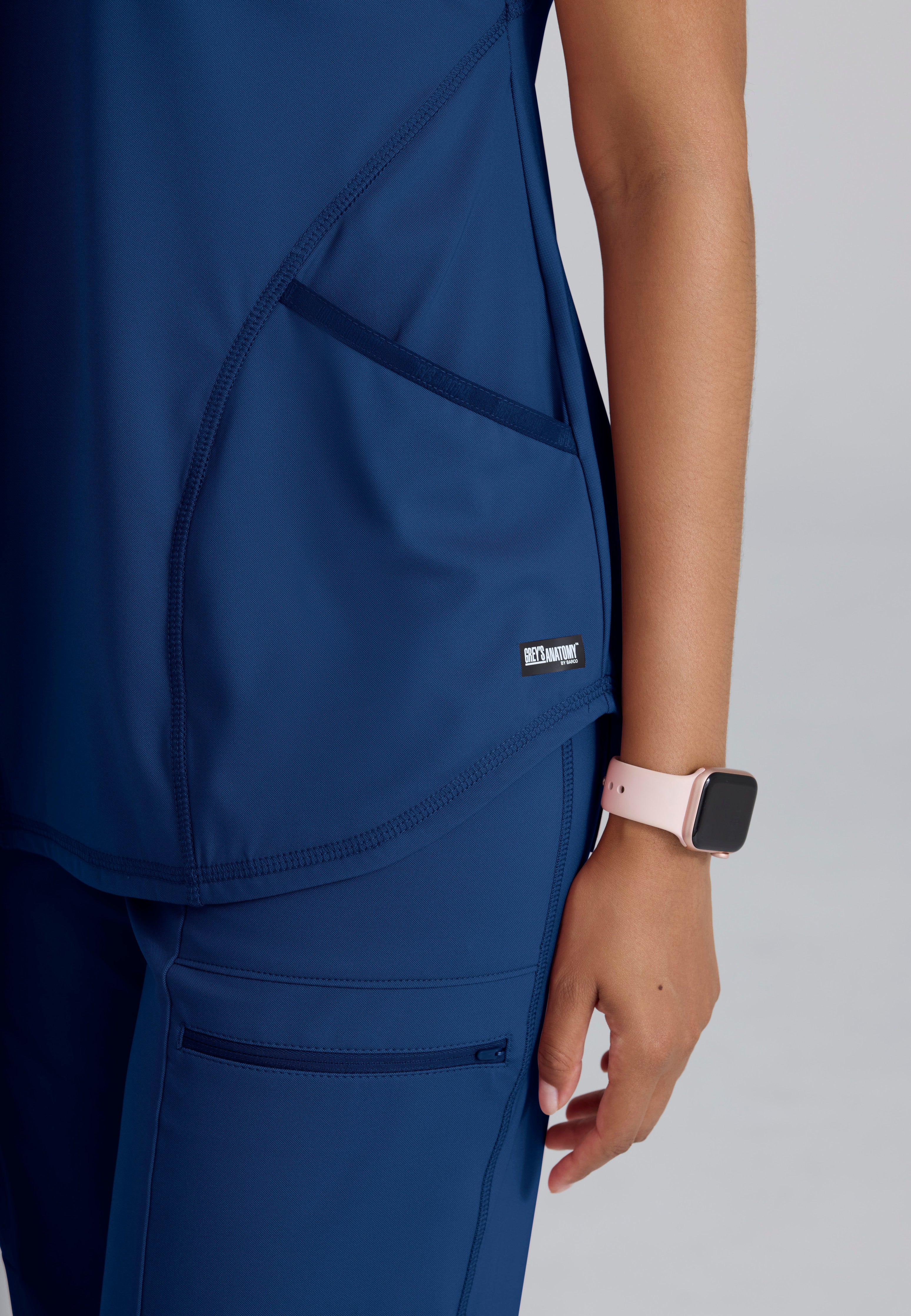 Detail Shot of the Define Contour Seam V-Neck Knit Top in Indigo from Grey's Anatomy™ by Barco Knit Stretch