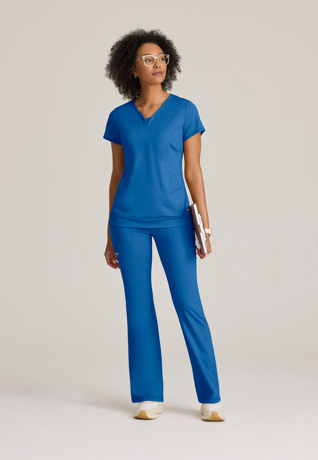 Full Body View of the Motivate Curved V-Neck Knit Scrub Top in New Royal from Grey's Anatomy™ by Barco Knit Stretch