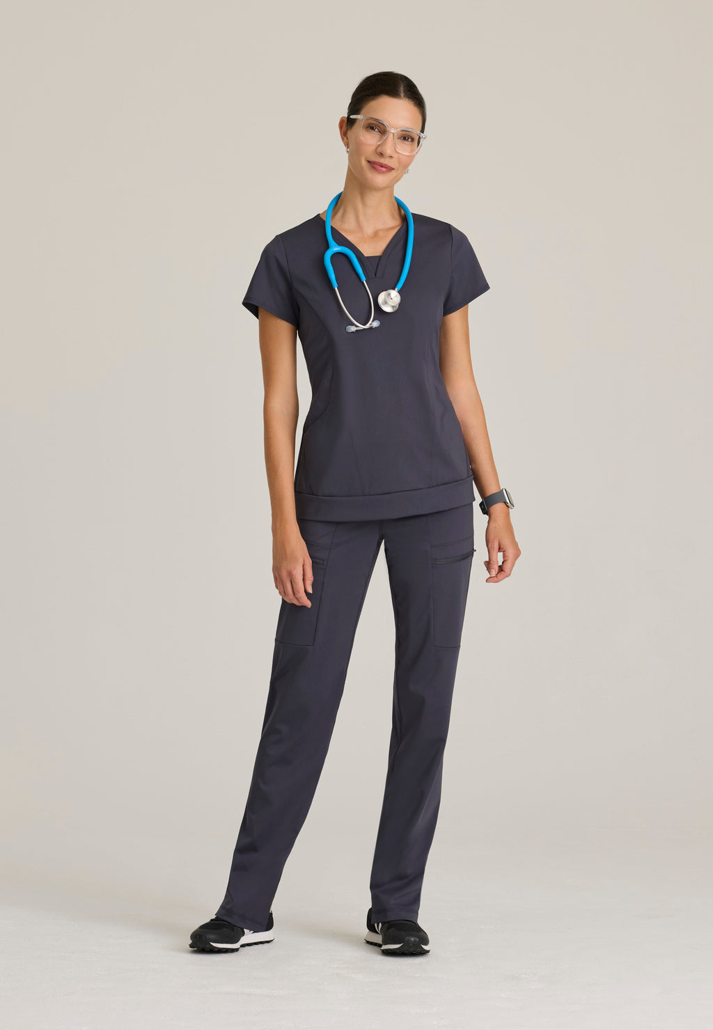 Full Body View of the Motivate Curved V-Neck Knit Scrub Top in Steel from Grey's Anatomy™ by Barco Knit Stretch