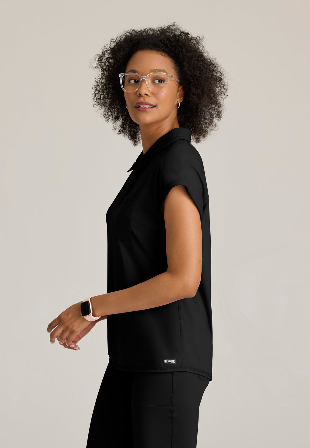 Side View of the Renew Snap Placket Knit Scrub Top in Black from Grey's Anatomy™ by Barco Knit Stretch