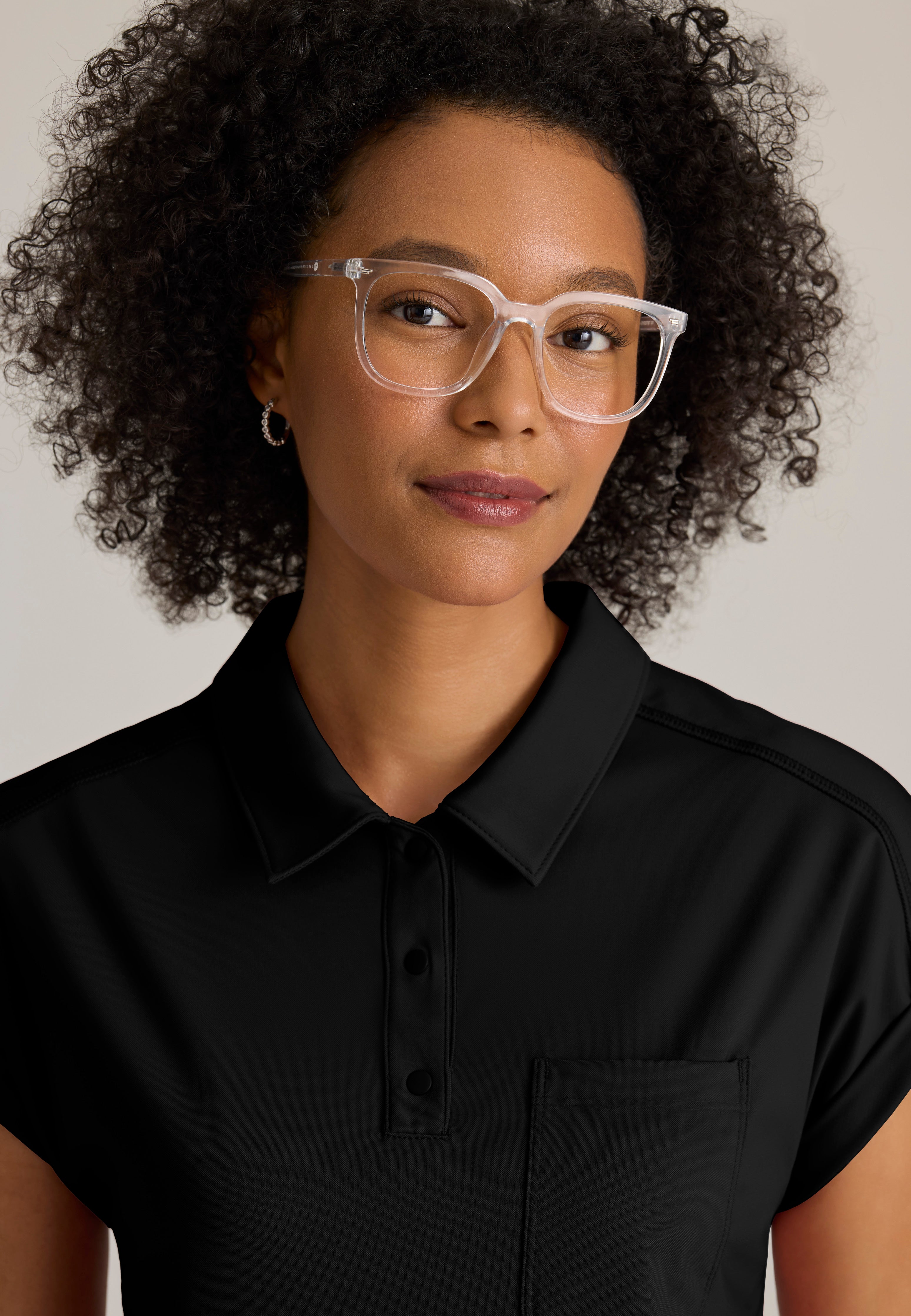 Detail Shot of the Renew Snap Placket Knit Scrub Top in Black from Grey's Anatomy™ by Barco Knit Stretch