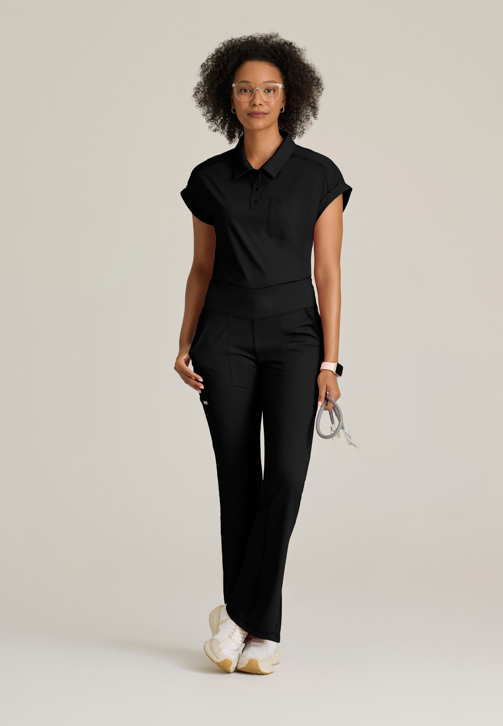 Full Body View of the Renew Snap Placket Knit Scrub Top in Black from Grey's Anatomy™ by Barco Knit Stretch