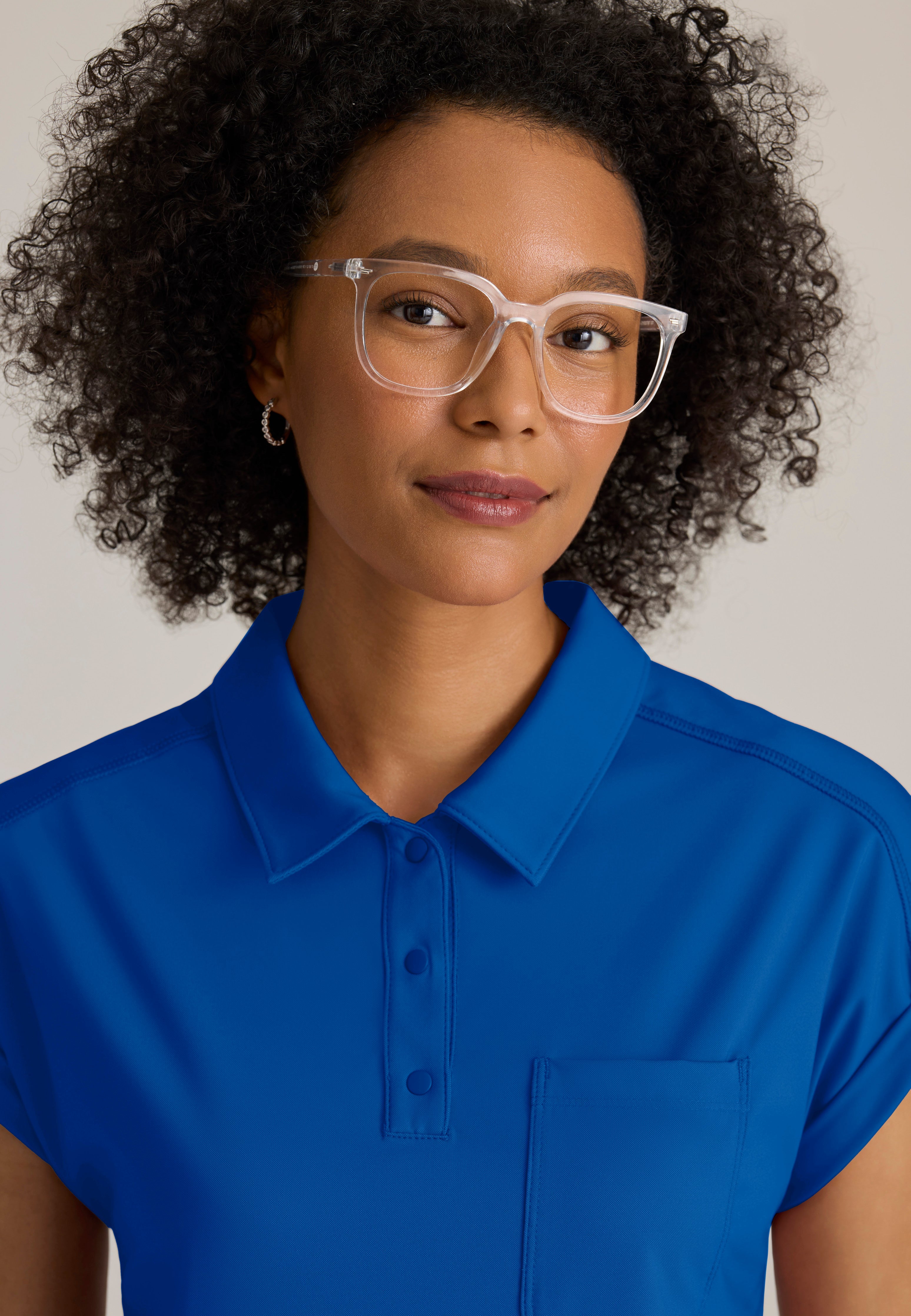 Detail Shot of the Renew Snap Placket Knit Scrub Top in New Royal from Grey's Anatomy™ by Barco Knit Stretch