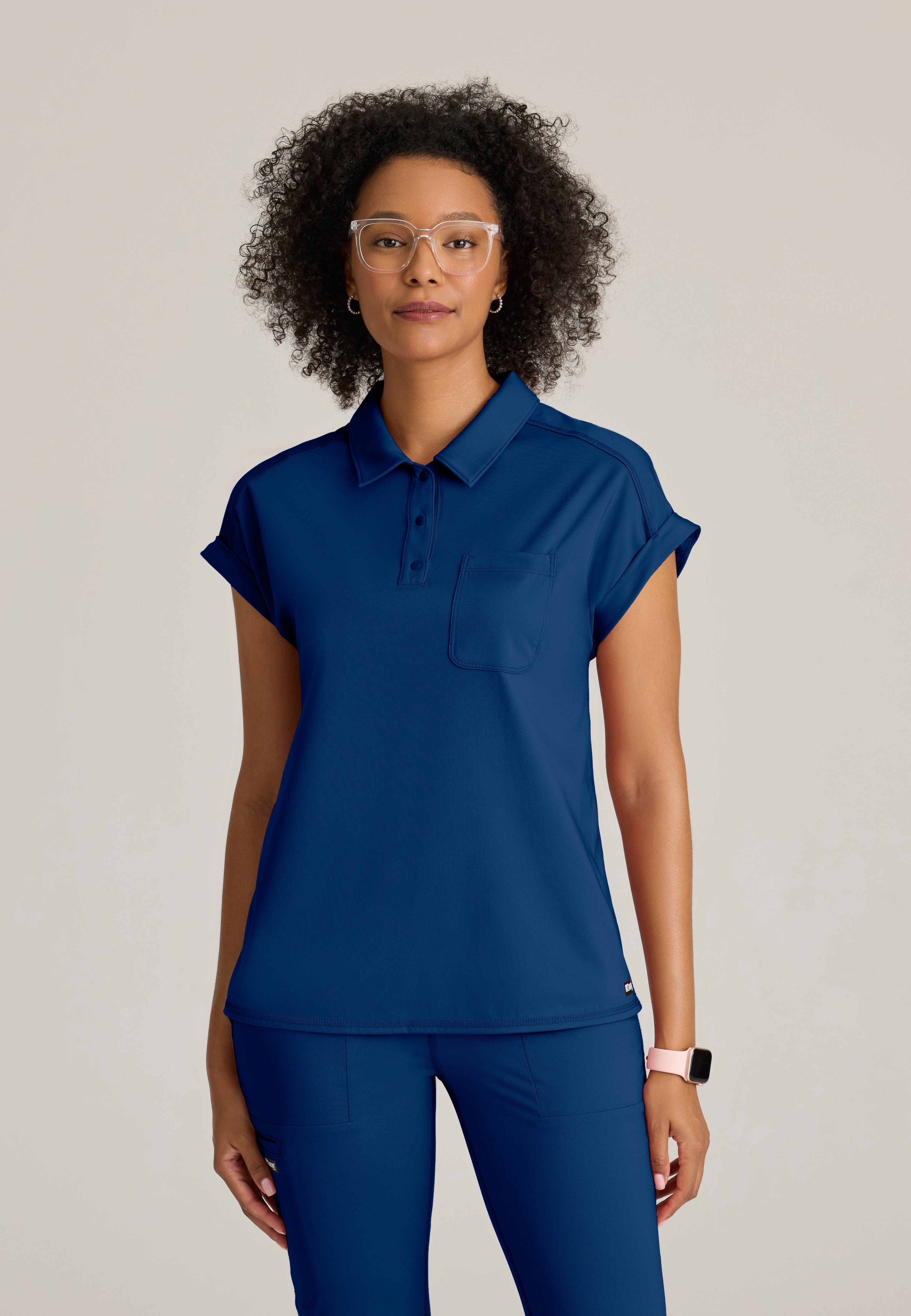 Front View of the Renew Snap Placket Knit Scrub Top in Indigo from Grey's Anatomy™ by Barco Knit Stretch