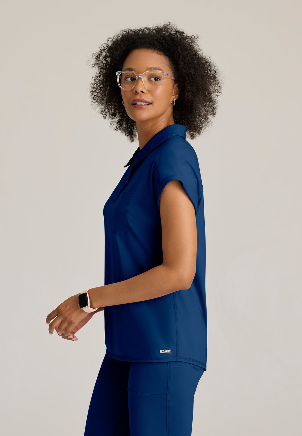 Side View of the Renew Snap Placket Knit Scrub Top in Indigo from Grey's Anatomy™ by Barco Knit Stretch