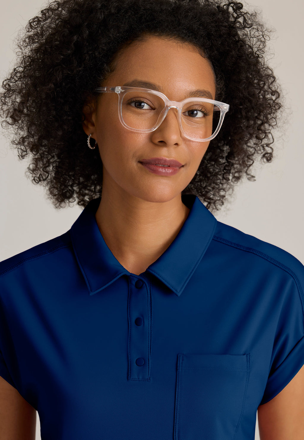 Detail Shot of the Renew Snap Placket Knit Scrub Top in Indigo from Grey's Anatomy™ by Barco Knit Stretch