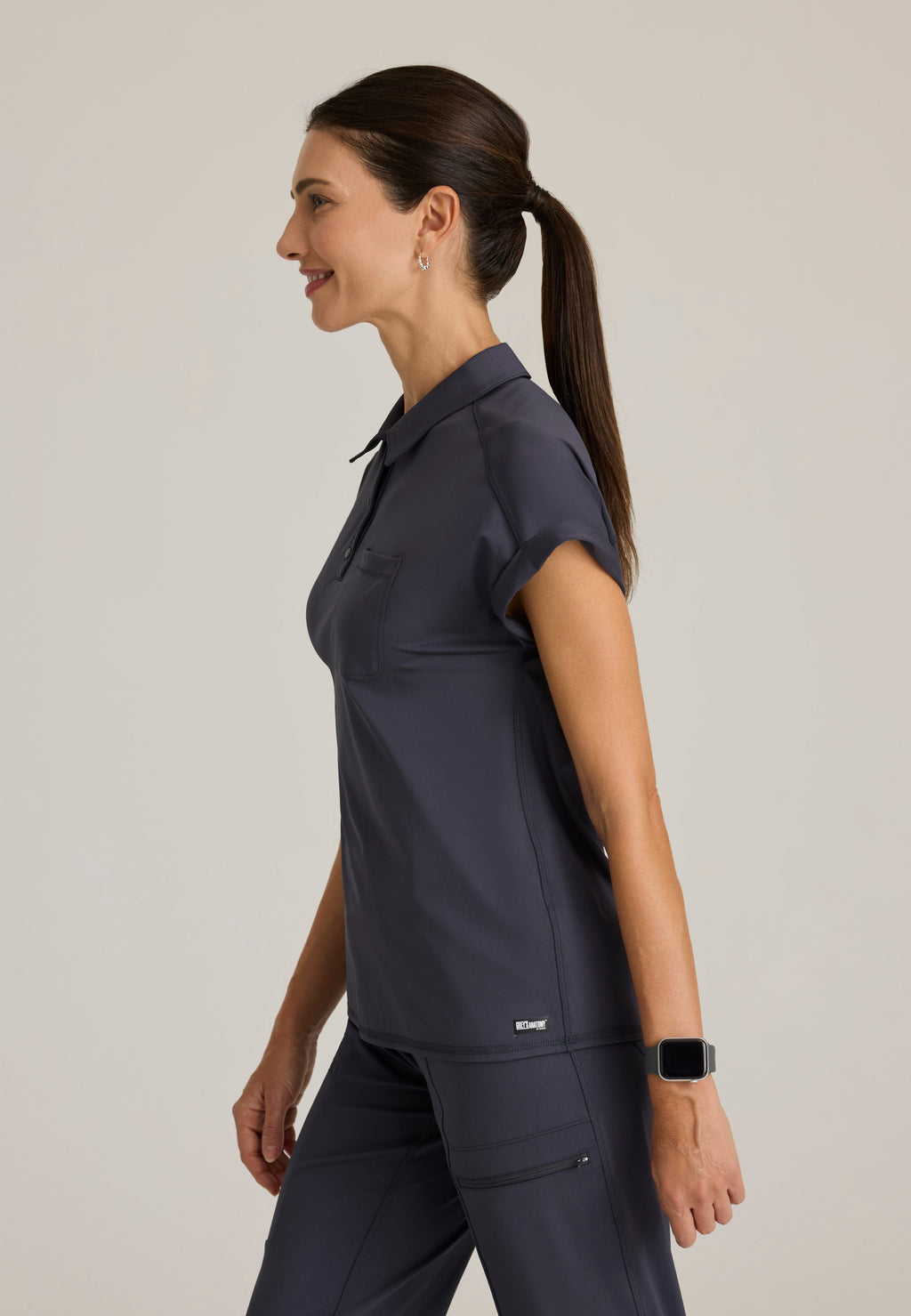 Side View of the Renew Snap Placket Knit Scrub Top in Steel from Grey's Anatomy™ by Barco Knit Stretch