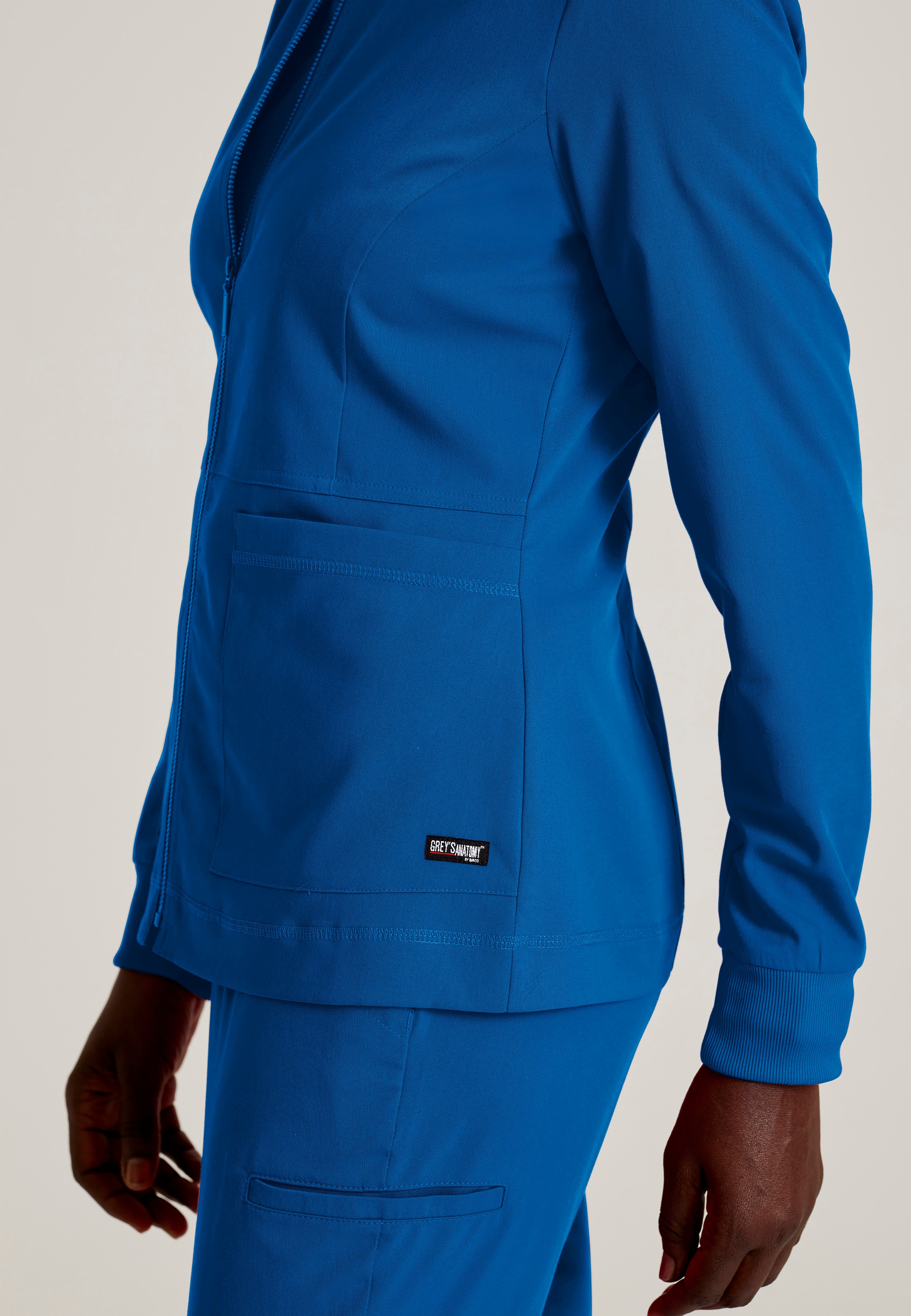 Detail Shot of the Millie 3-Pocket Crewneck Scrub Jacket in New Royal from Grey's Anatomy™ by Barco Spandex Stretch