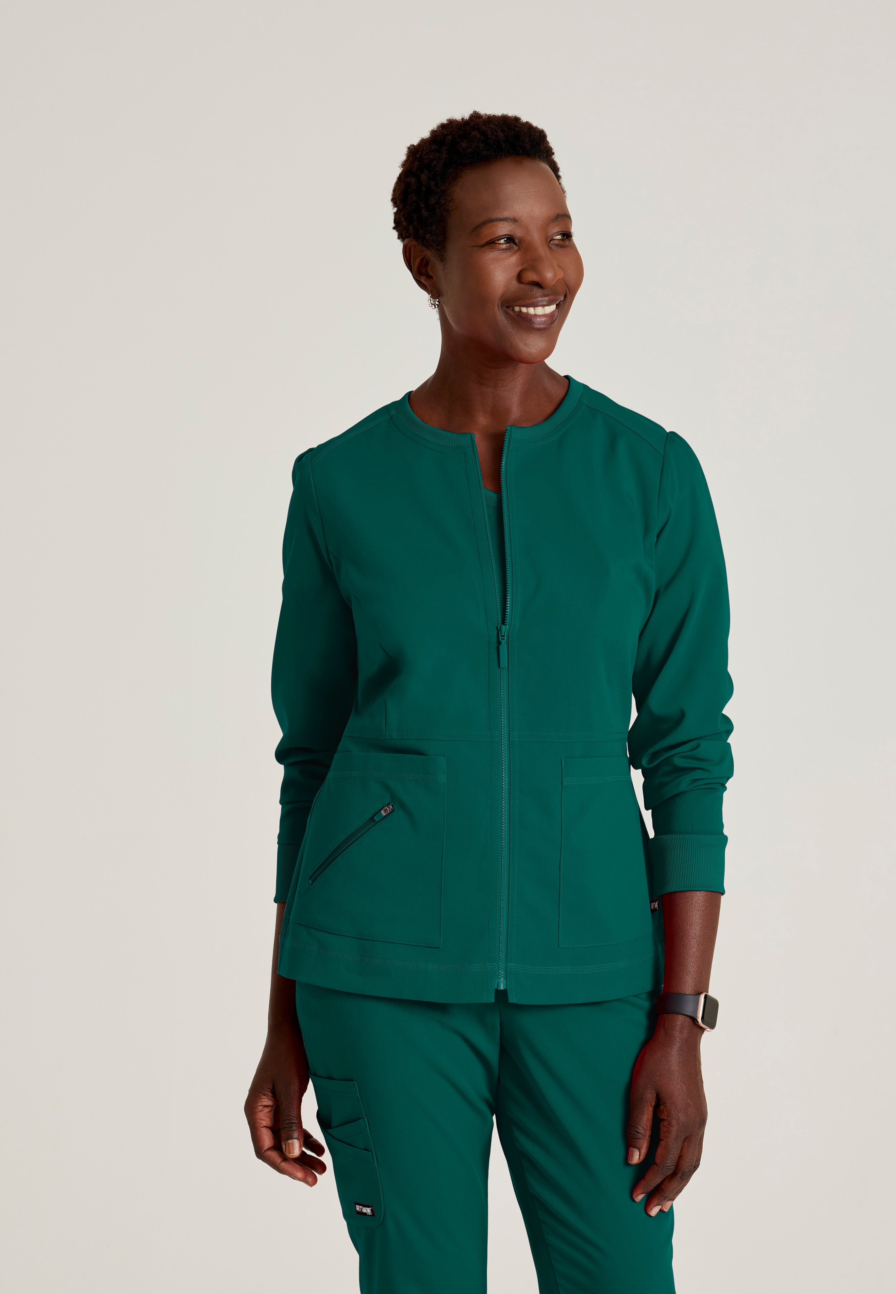 Front View of the Millie 3-Pocket Crewneck Scrub Jacket in Hunter Green from Grey's Anatomy™ by Barco Spandex Stretch