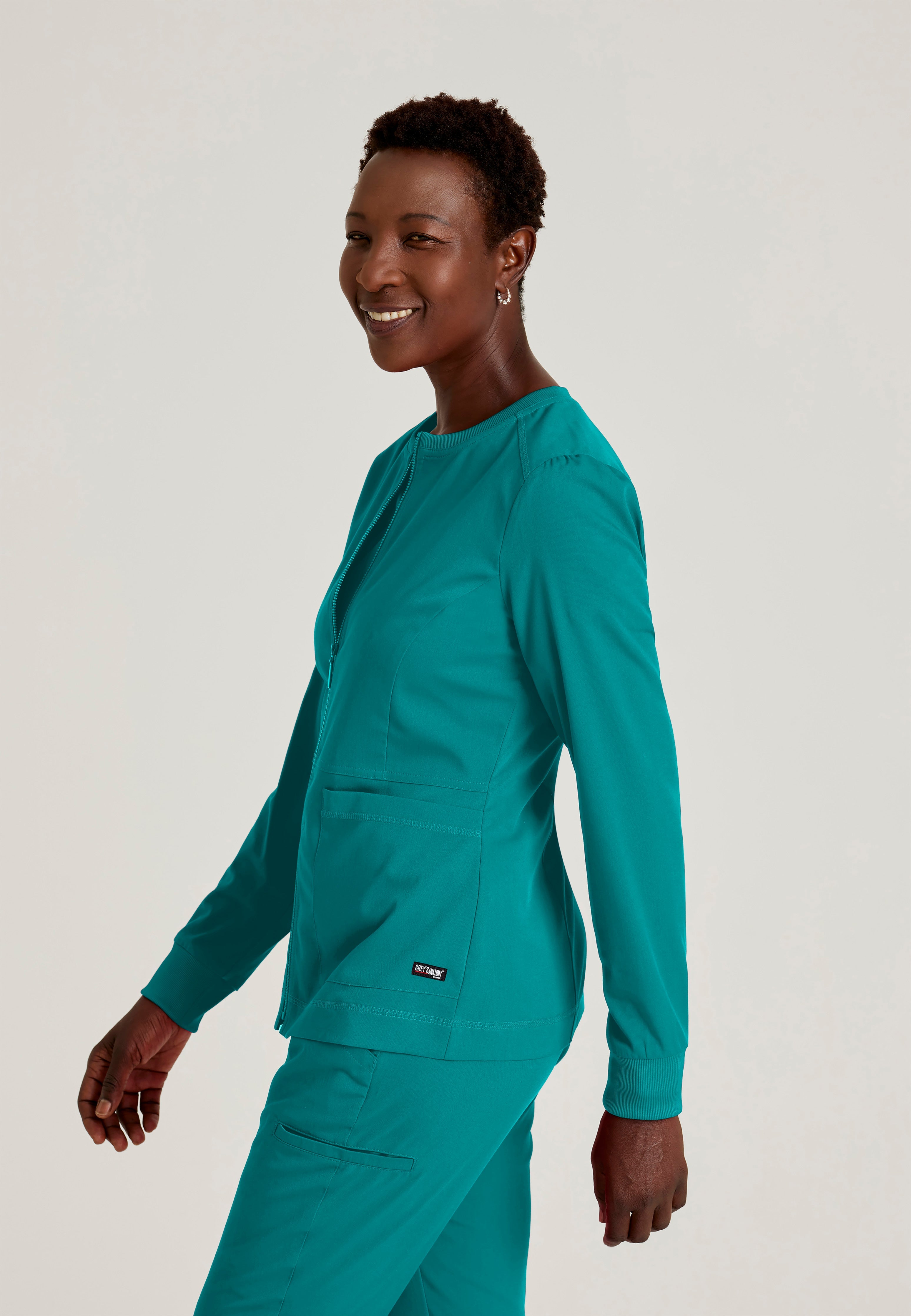 Side View of the Millie 3-Pocket Crewneck Scrub Jacket in Teal from Grey's Anatomy™ by Barco Spandex Stretch