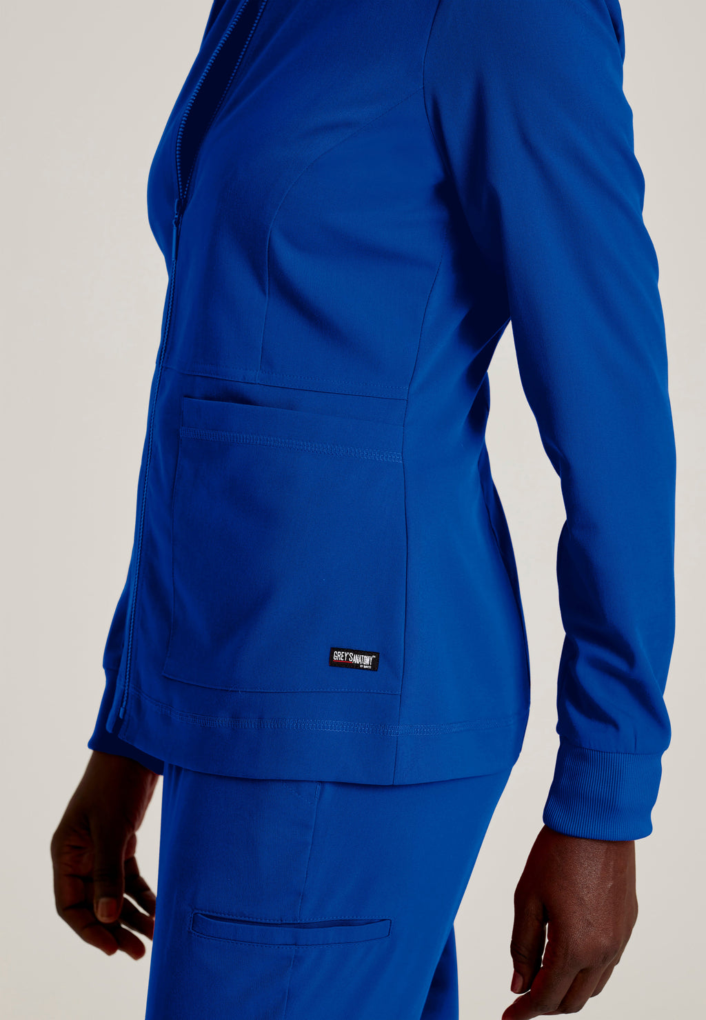 Detail Shot of the Millie 3-Pocket Crewneck Scrub Jacket in Galaxy from Grey's Anatomy™ by Barco Spandex Stretch