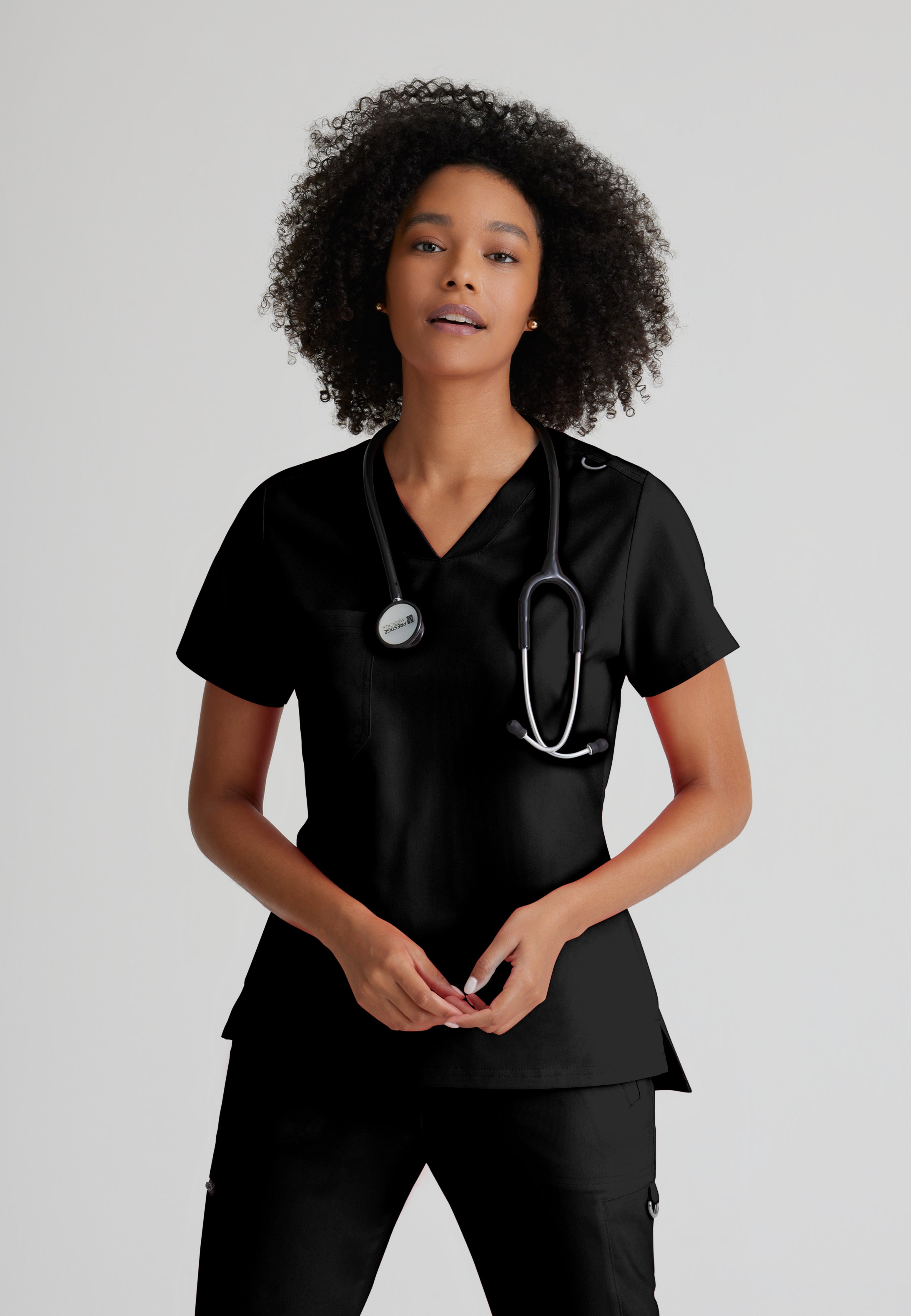 Front View of the Bree 1-Pocket Tuck-In Scrub Top in Black from Grey's Anatomy™ by Barco Spandex Stretch