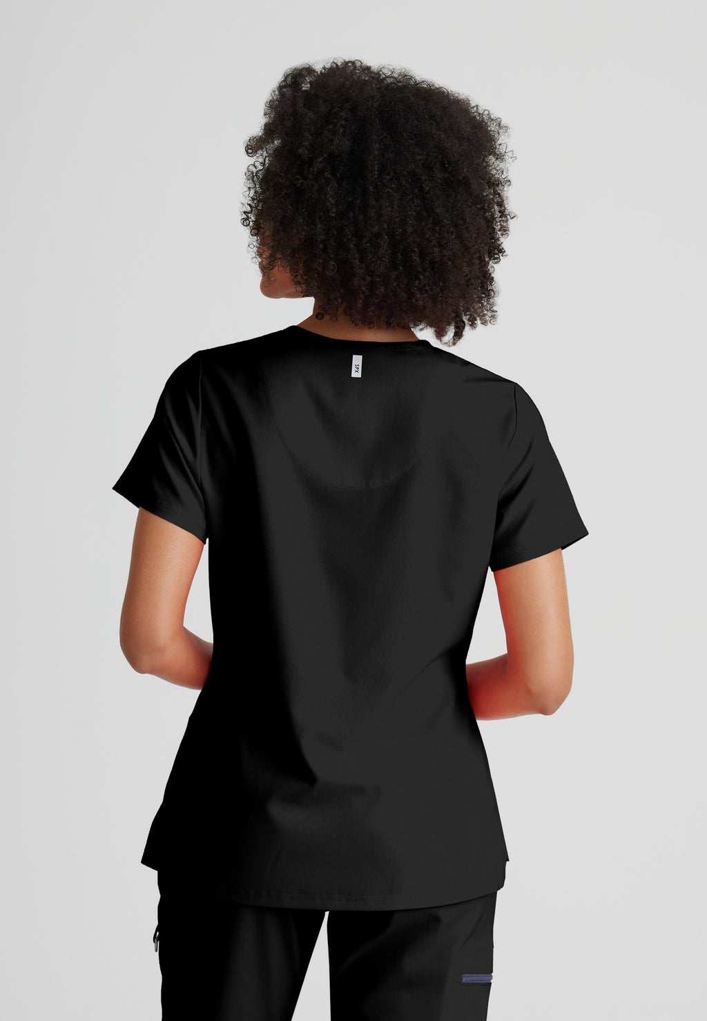 Back View of the Bree 1-Pocket Tuck-In Scrub Top in Black from Grey's Anatomy™ by Barco Spandex Stretch