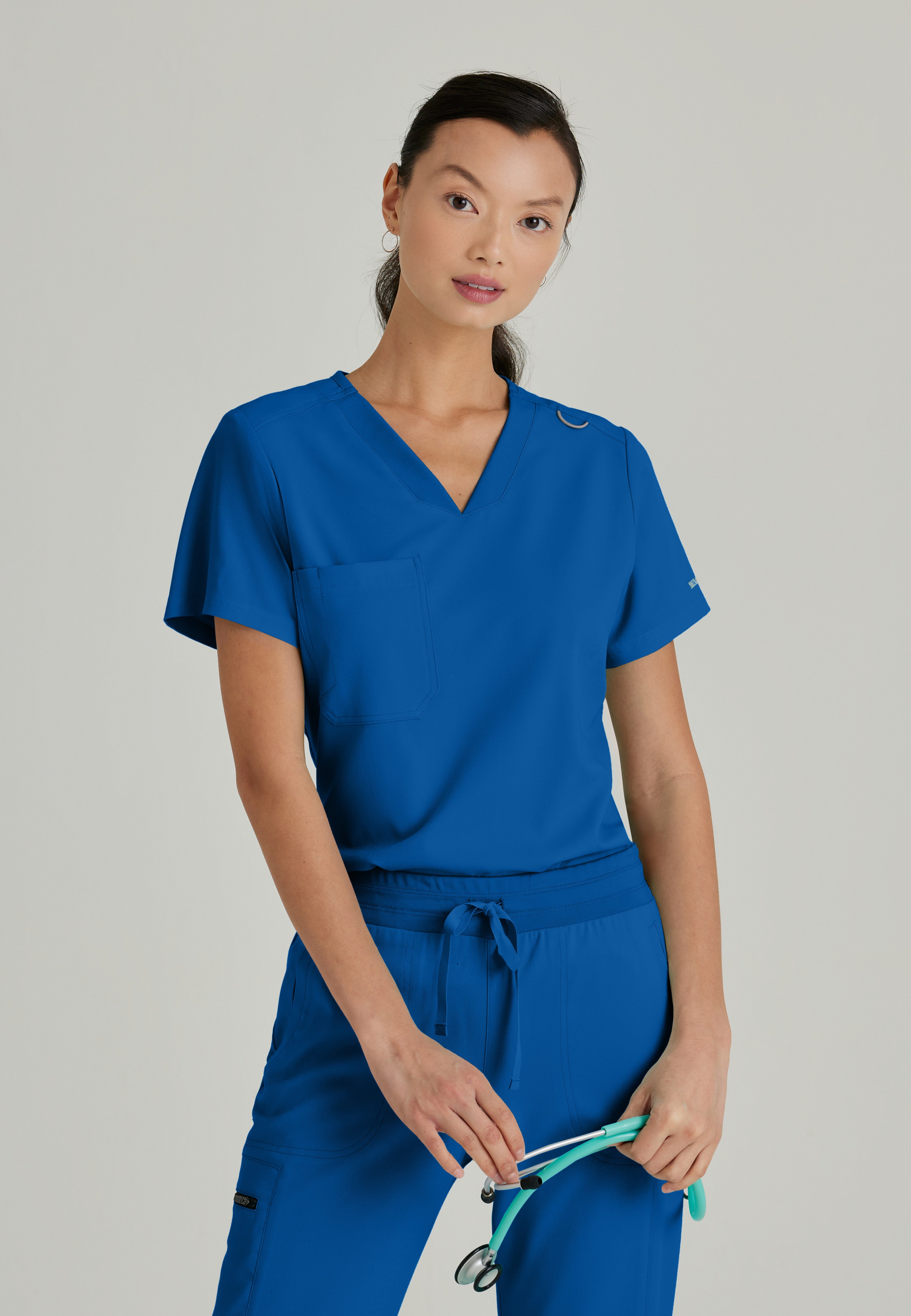 Front View of the Bree 1-Pocket Tuck-In Scrub Top in New Royal from Grey's Anatomy™ by Barco Spandex Stretch
