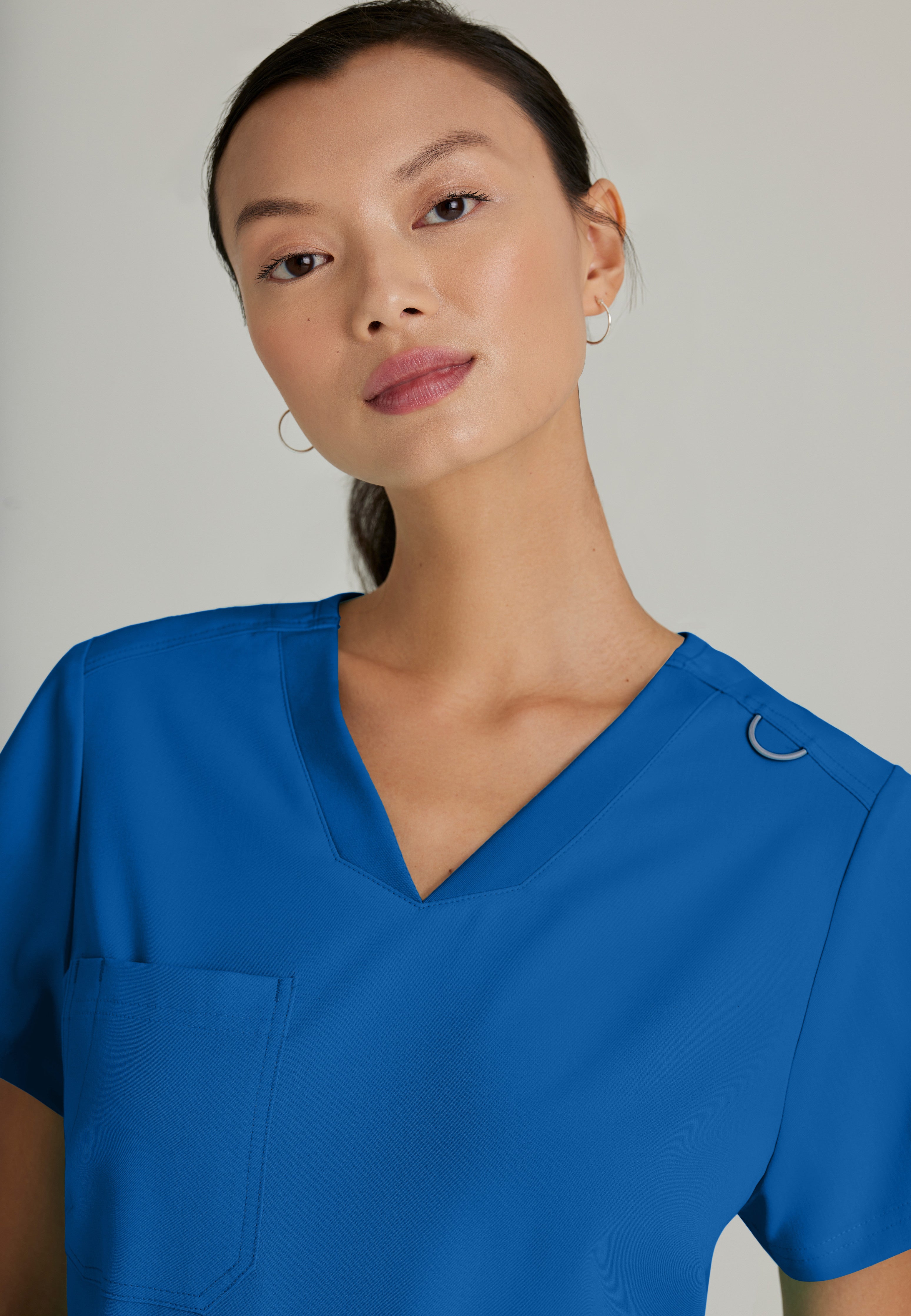 Back View of the Bree 1-Pocket Tuck-In Scrub Top in New Royal from Grey's Anatomy™ by Barco Spandex Stretch