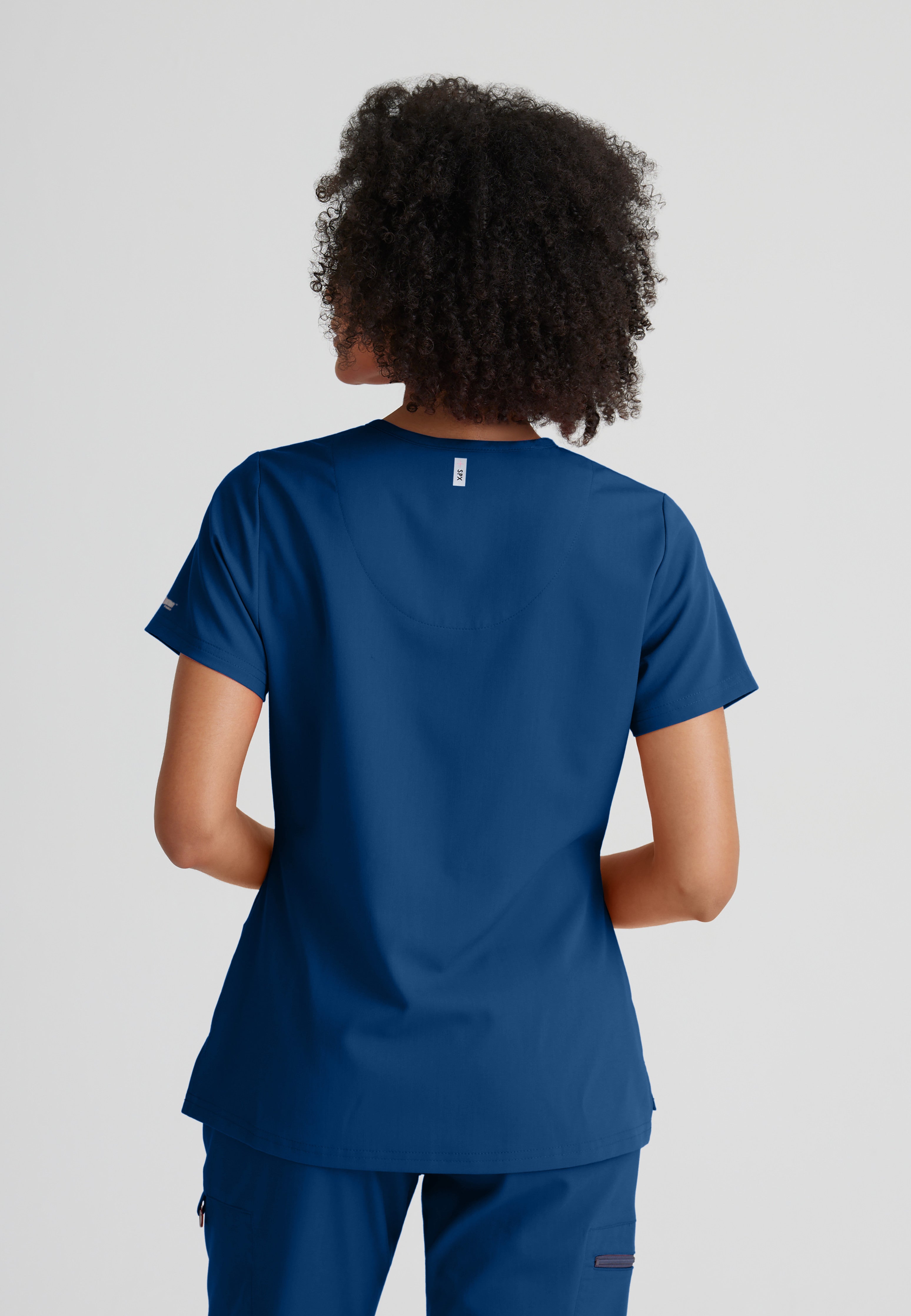 Back View of the Bree 1-Pocket Tuck-In Scrub Top in Indigo from Grey's Anatomy™ by Barco Spandex Stretch