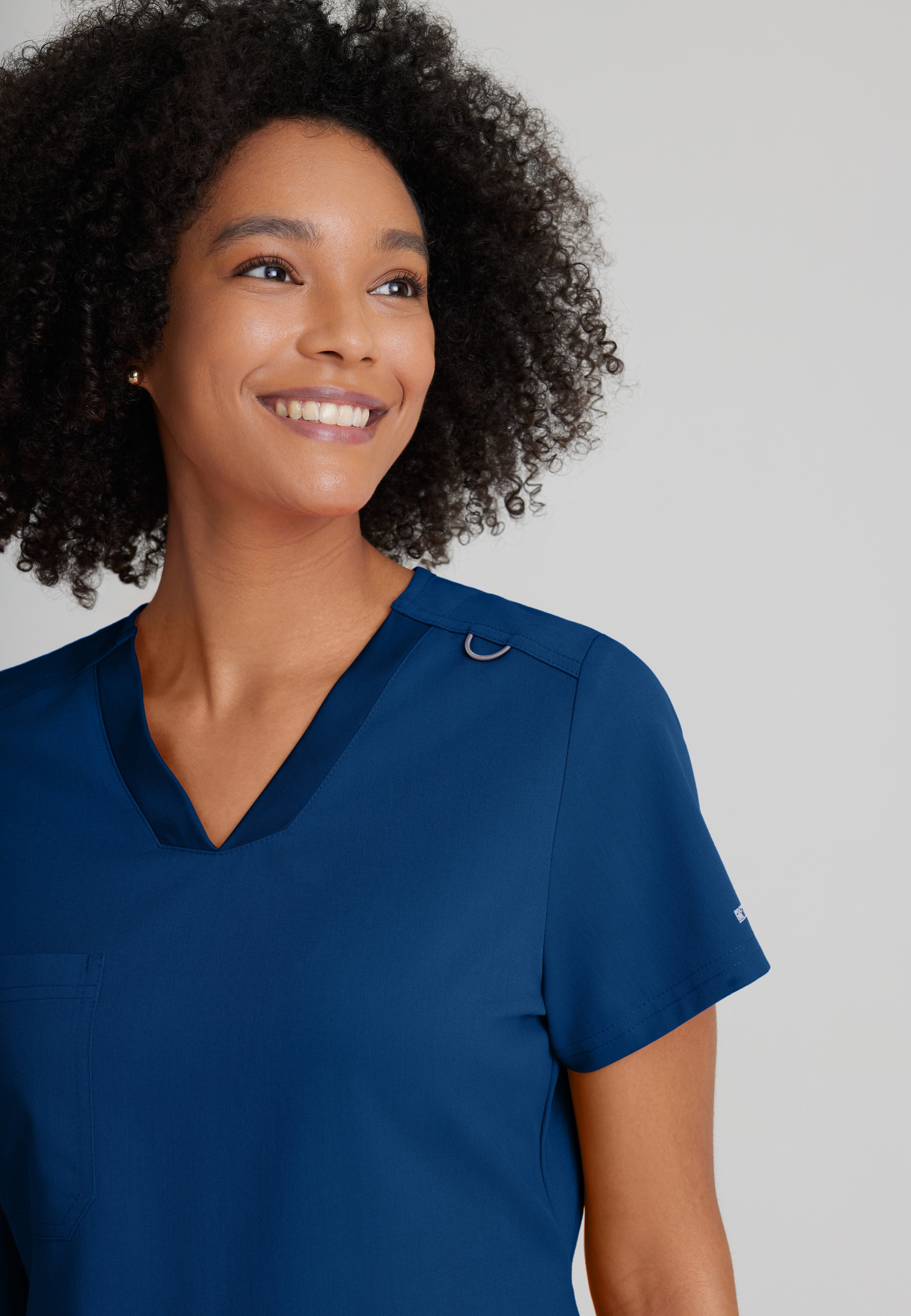 Detail Shot of the Bree 1-Pocket Tuck-In Scrub Top in Indigo from Grey's Anatomy™ by Barco Spandex Stretch