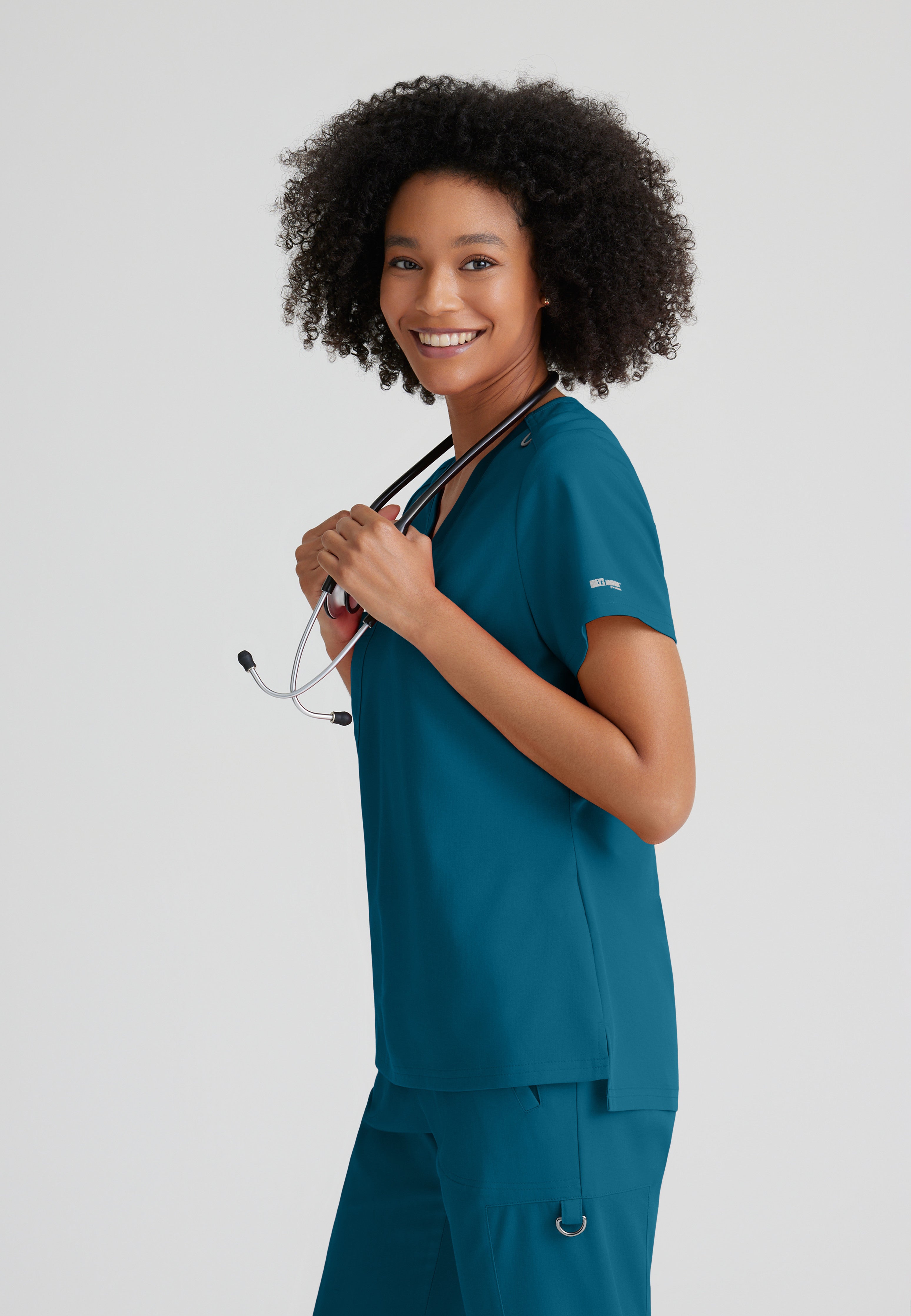Side View of the Bree 1-Pocket Tuck-In Scrub Top in Bahama from Grey's Anatomy™ by Barco Spandex Stretch