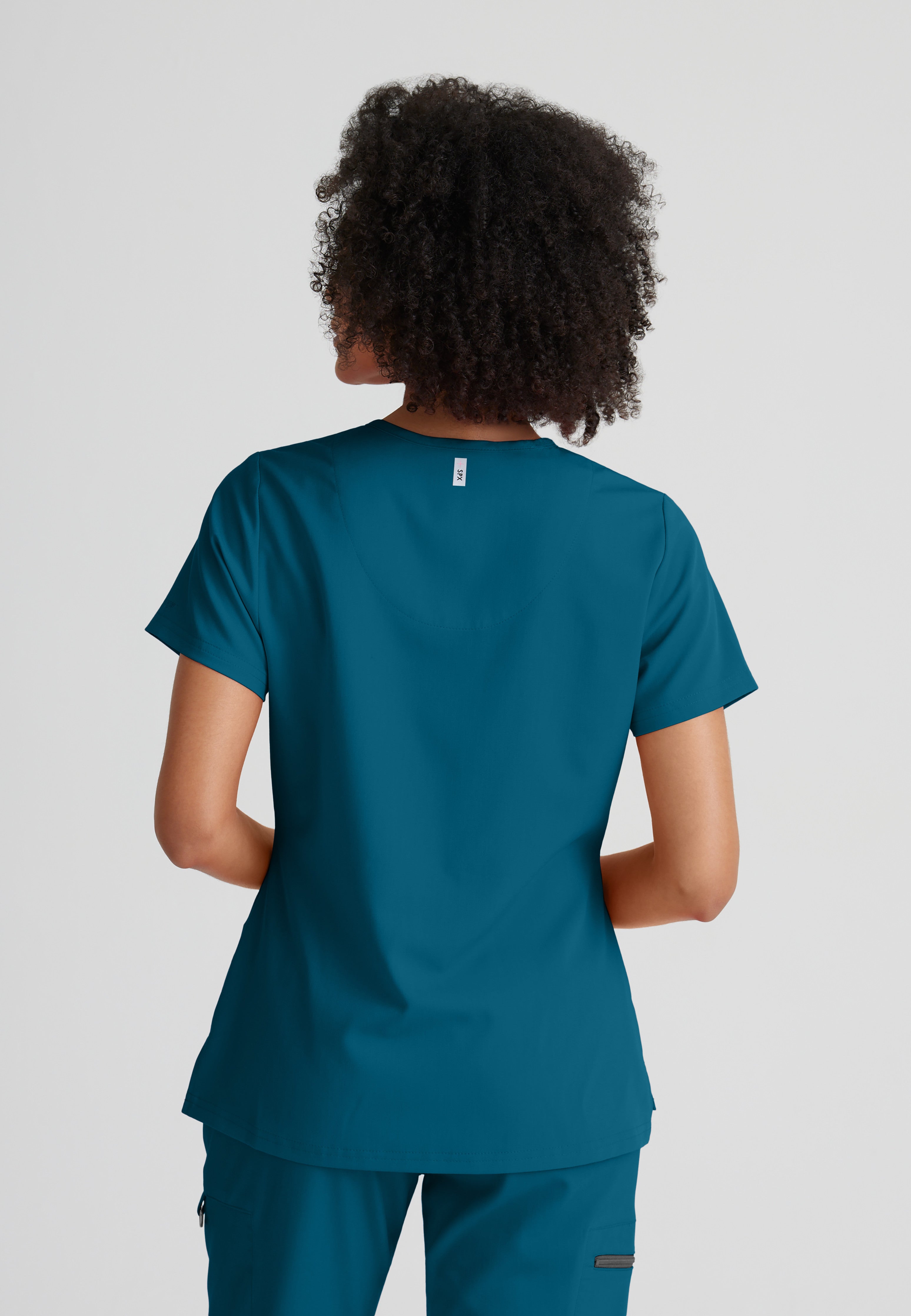 Back View of the Bree 1-Pocket Tuck-In Scrub Top in Bahama from Grey's Anatomy™ by Barco Spandex Stretch