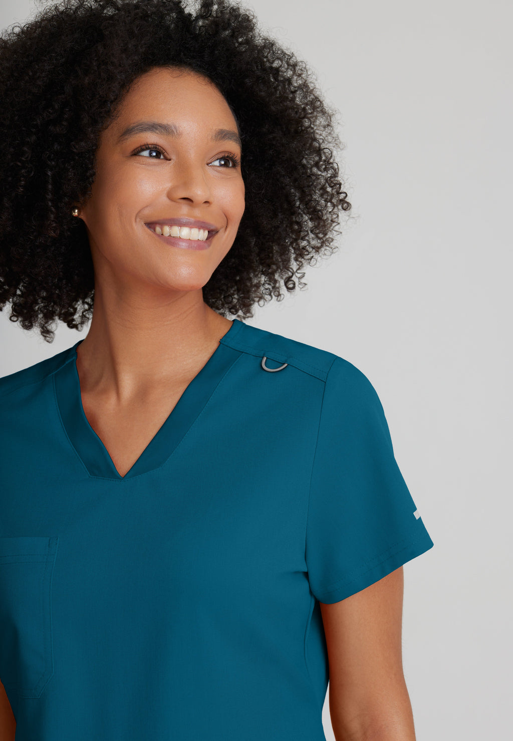 Detail Shot of the Bree 1-Pocket Tuck-In Scrub Top in Bahama from Grey's Anatomy™ by Barco Spandex Stretch