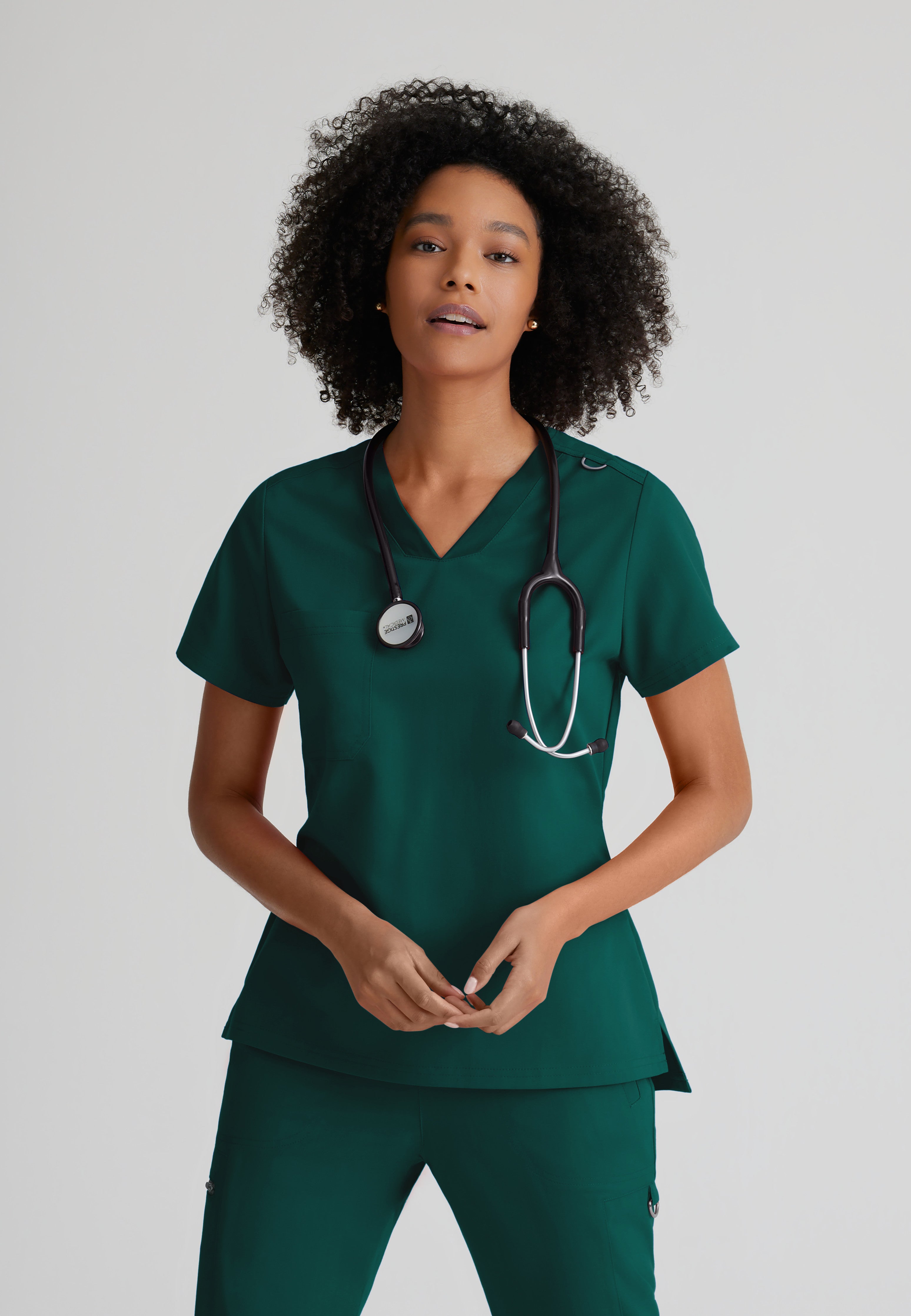 Front View of the Bree 1-Pocket Tuck-In Scrub Top in Hunter Green from Grey's Anatomy™ by Barco Spandex Stretch