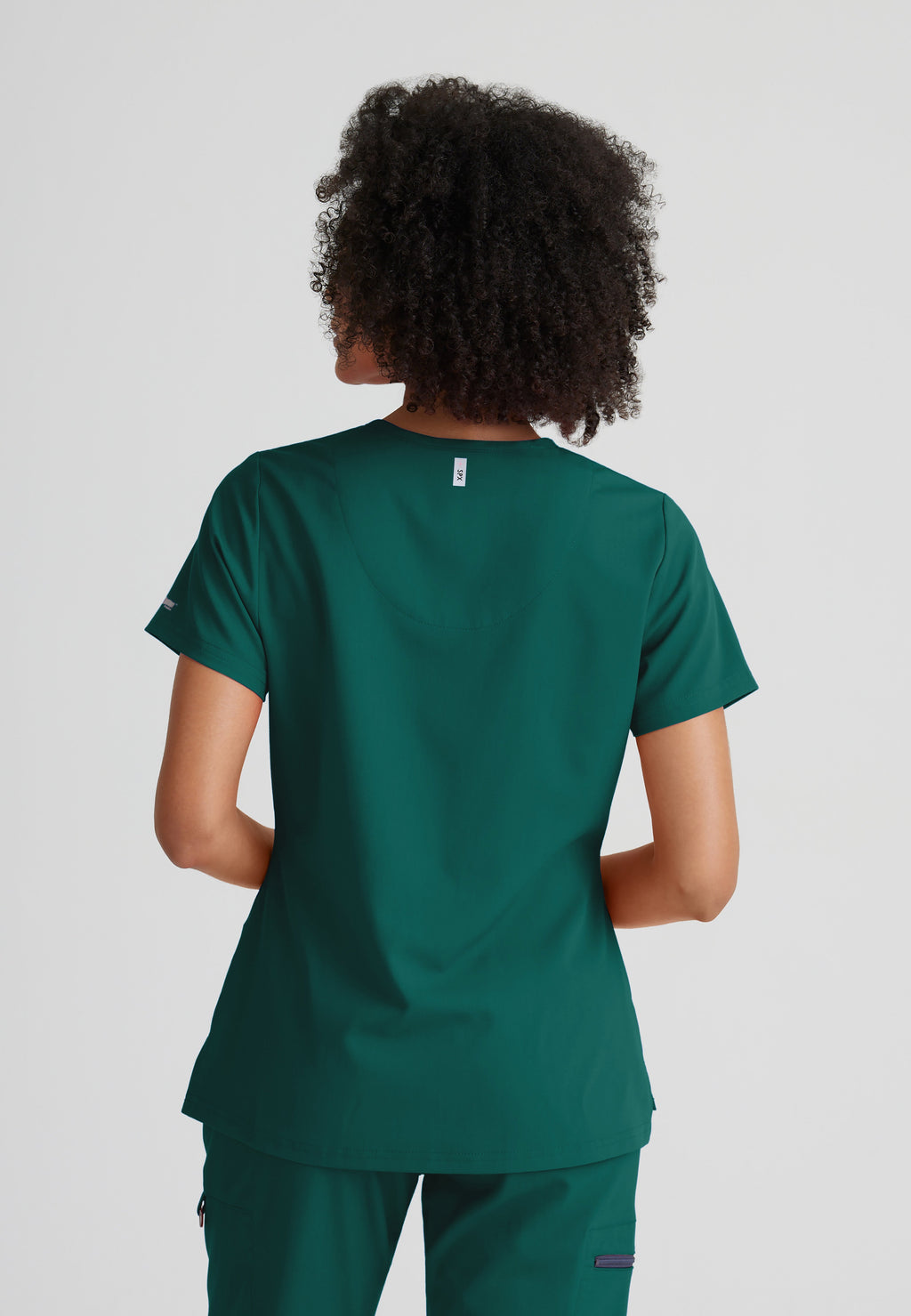 Back View of the Bree 1-Pocket Tuck-In Scrub Top in Hunter Green from Grey's Anatomy™ by Barco Spandex Stretch