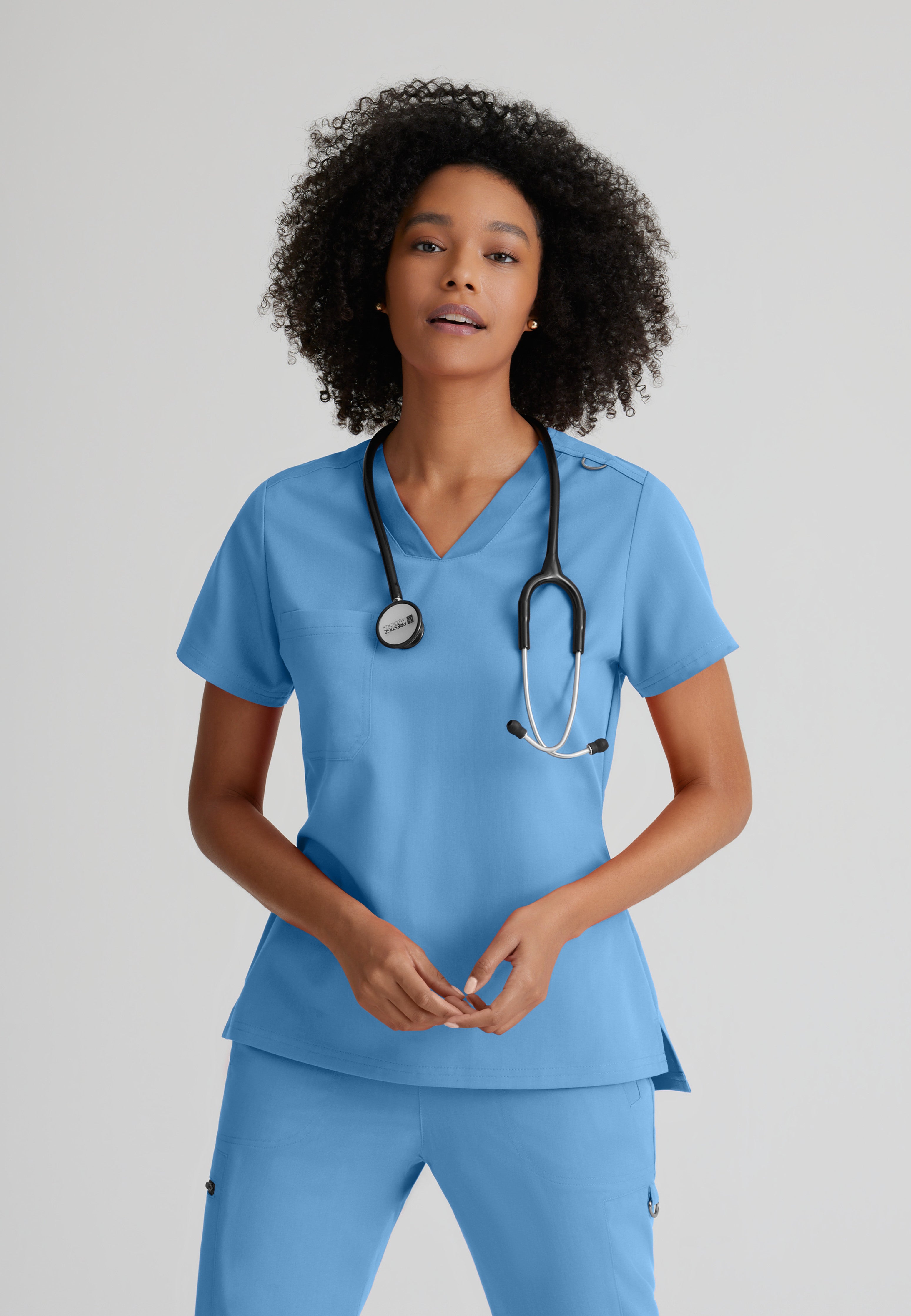 Front View of the Bree 1-Pocket Tuck-In Scrub Top in Ciel Blue from Grey's Anatomy™ by Barco Spandex Stretch
