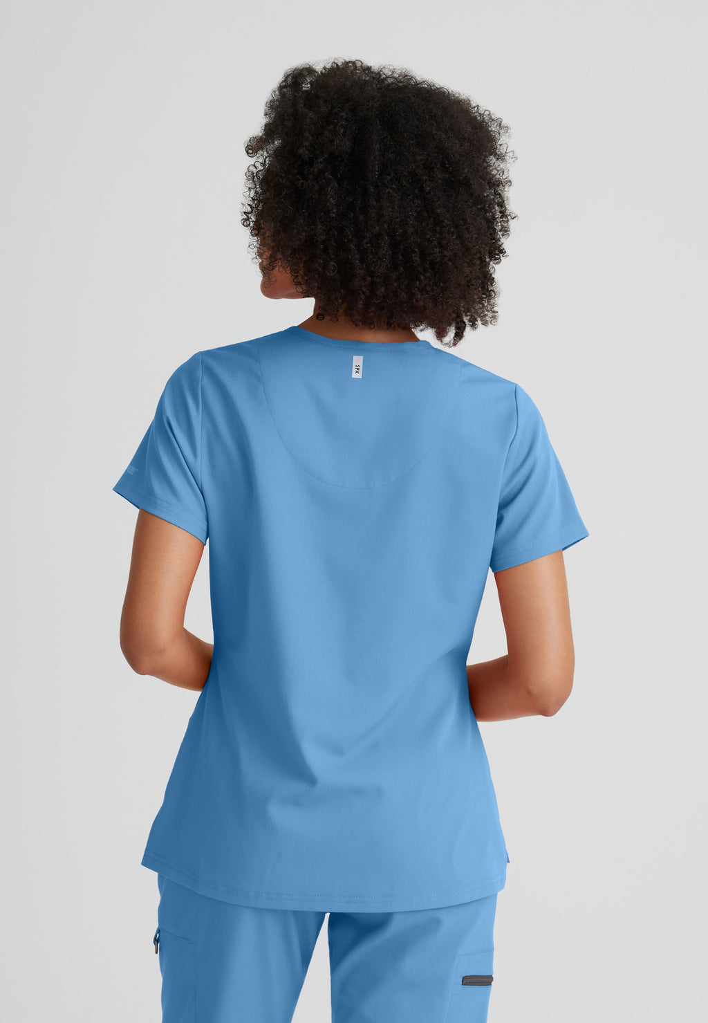 Back View of the Bree 1-Pocket Tuck-In Scrub Top in Ciel Blue from Grey's Anatomy™ by Barco Spandex Stretch