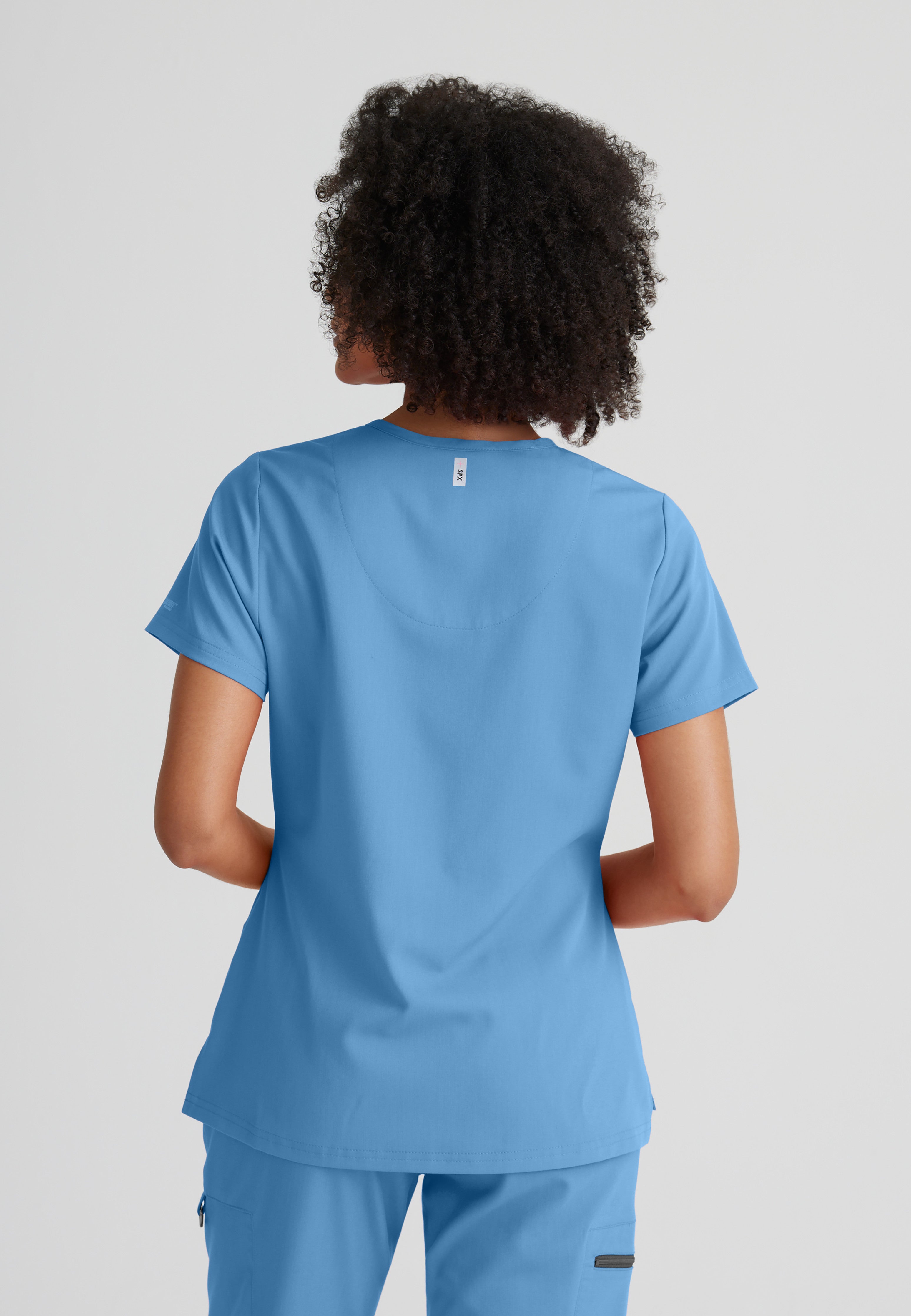 Back View of the Bree 1-Pocket Tuck-In Scrub Top in Ciel Blue from Grey's Anatomy™ by Barco Spandex Stretch