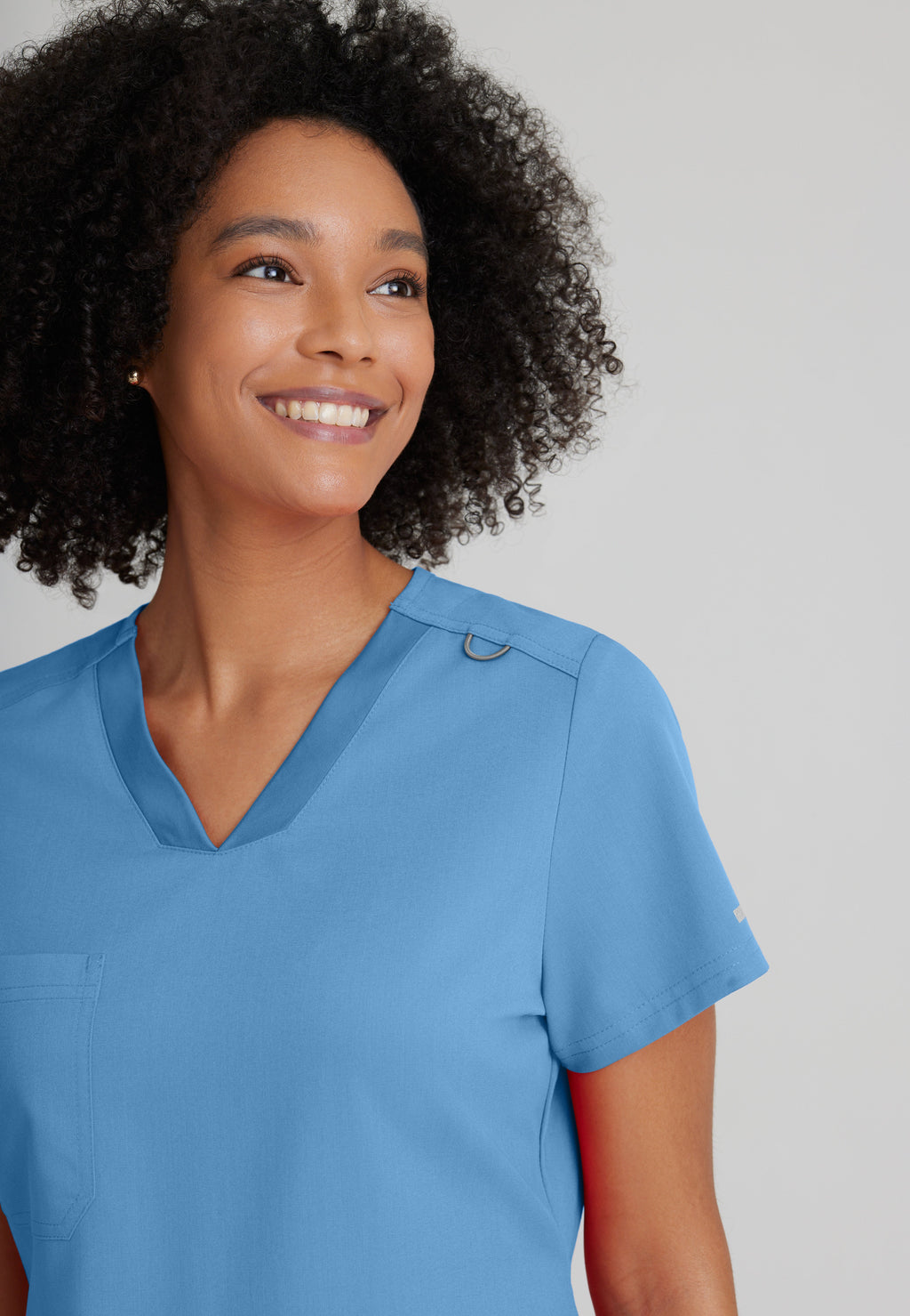 Detail Shot of the Bree 1-Pocket Tuck-In Scrub Top in Ciel Blue from Grey's Anatomy™ by Barco Spandex Stretch