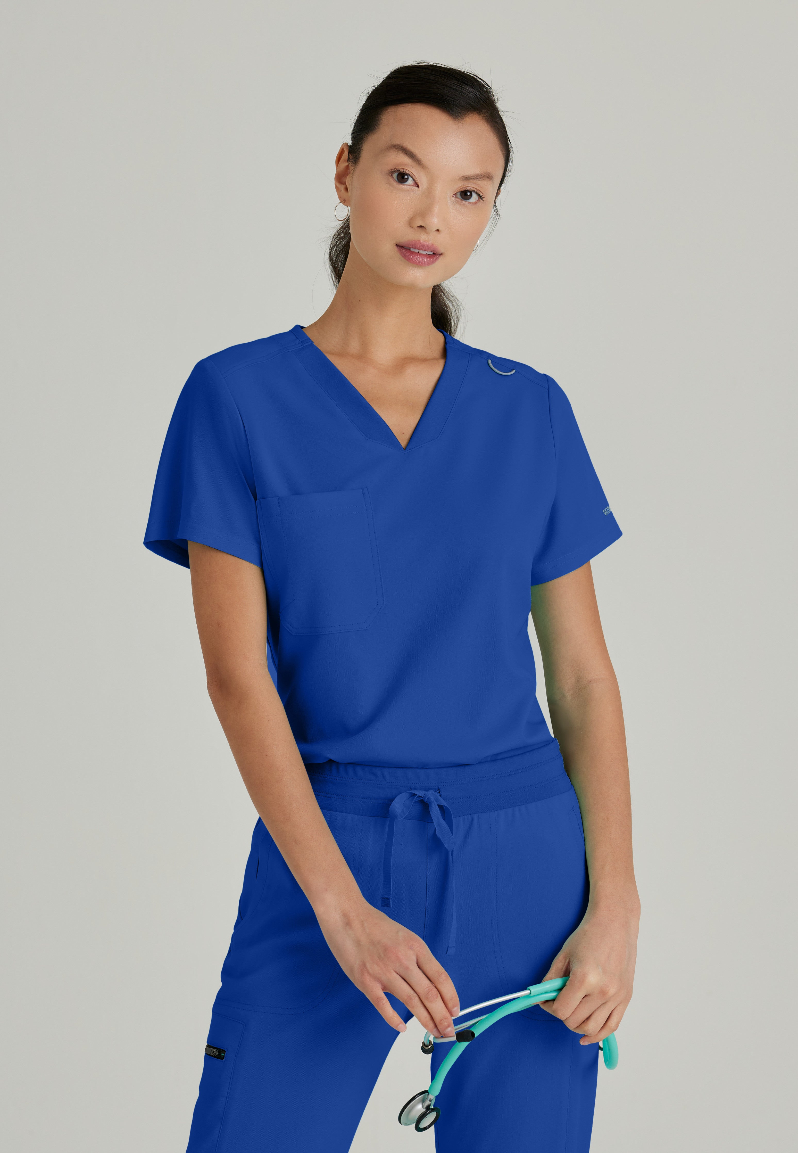 Front View of the Bree 1-Pocket Tuck-In Scrub Top in Galaxy from Grey's Anatomy™ by Barco Spandex Stretch