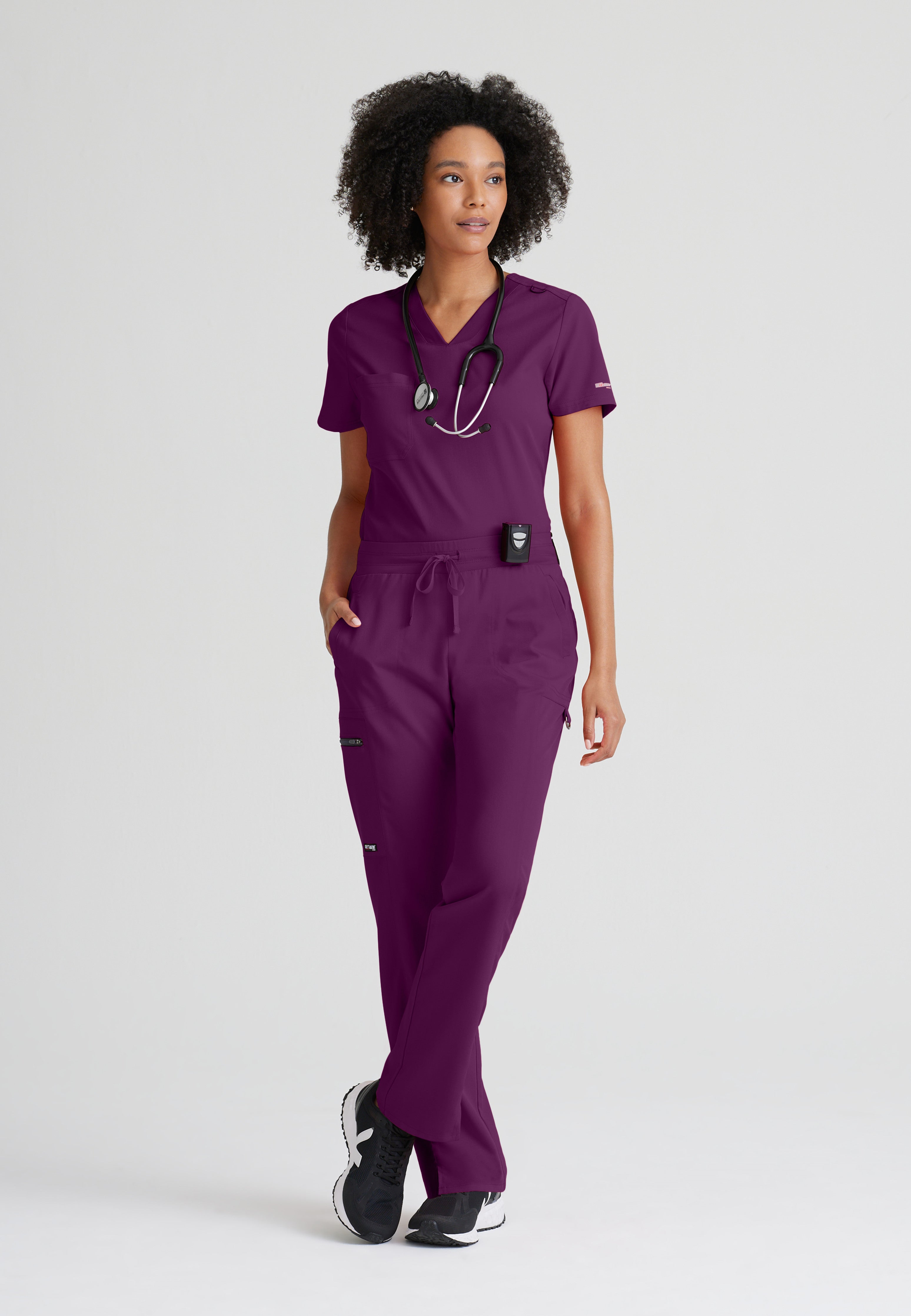 Full Body View of the Bree 1-Pocket Tuck-In Scrub Top in Wine from Grey's Anatomy™ by Barco Spandex Stretch