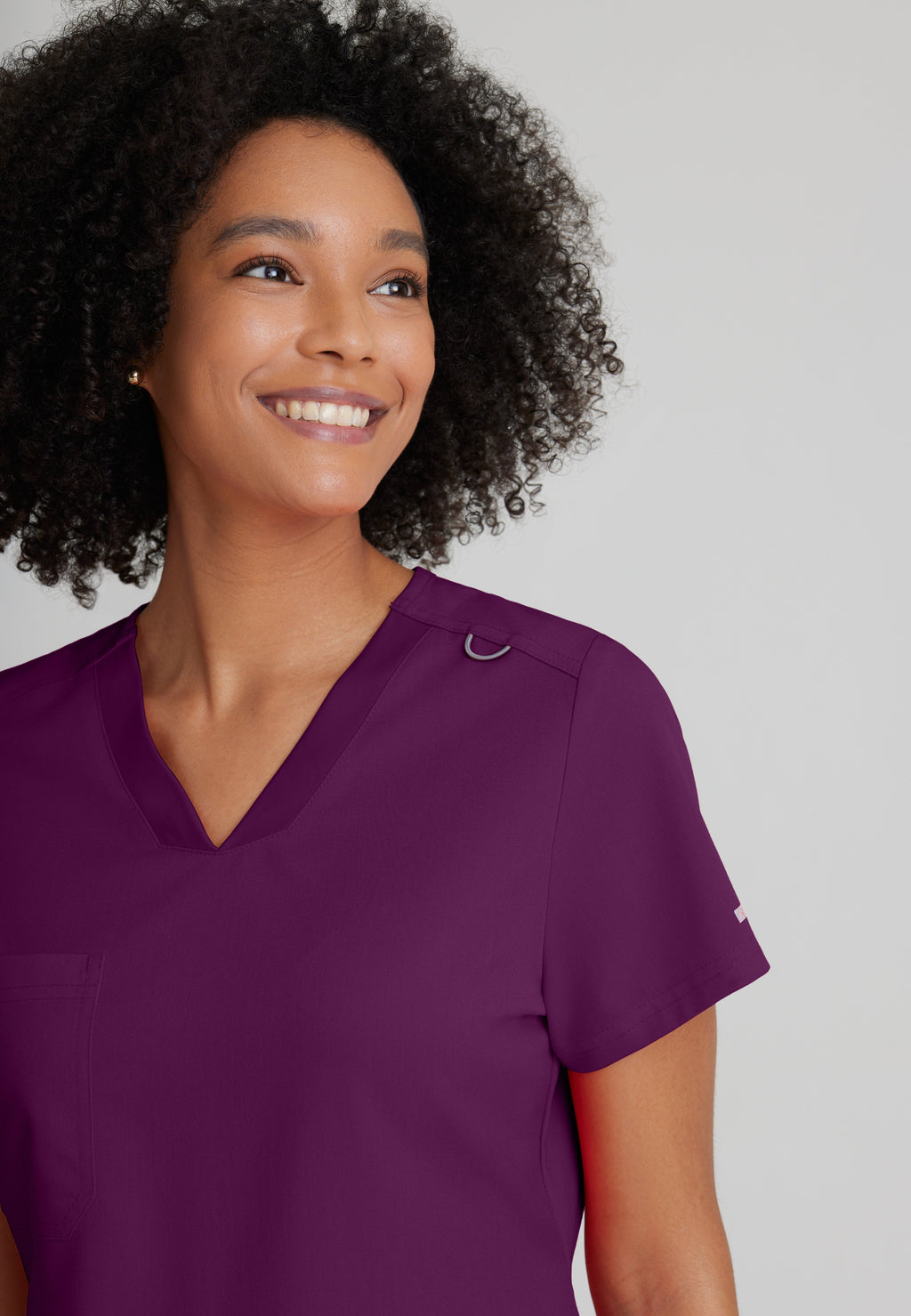 Detail Shot of the Bree 1-Pocket Tuck-In Scrub Top in Wine from Grey's Anatomy™ by Barco Spandex Stretch