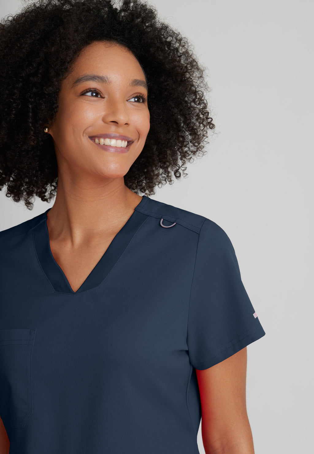 Detail Shot of the Bree 1-Pocket Tuck-In Scrub Top in Steel from Grey's Anatomy™ by Barco Spandex Stretch
