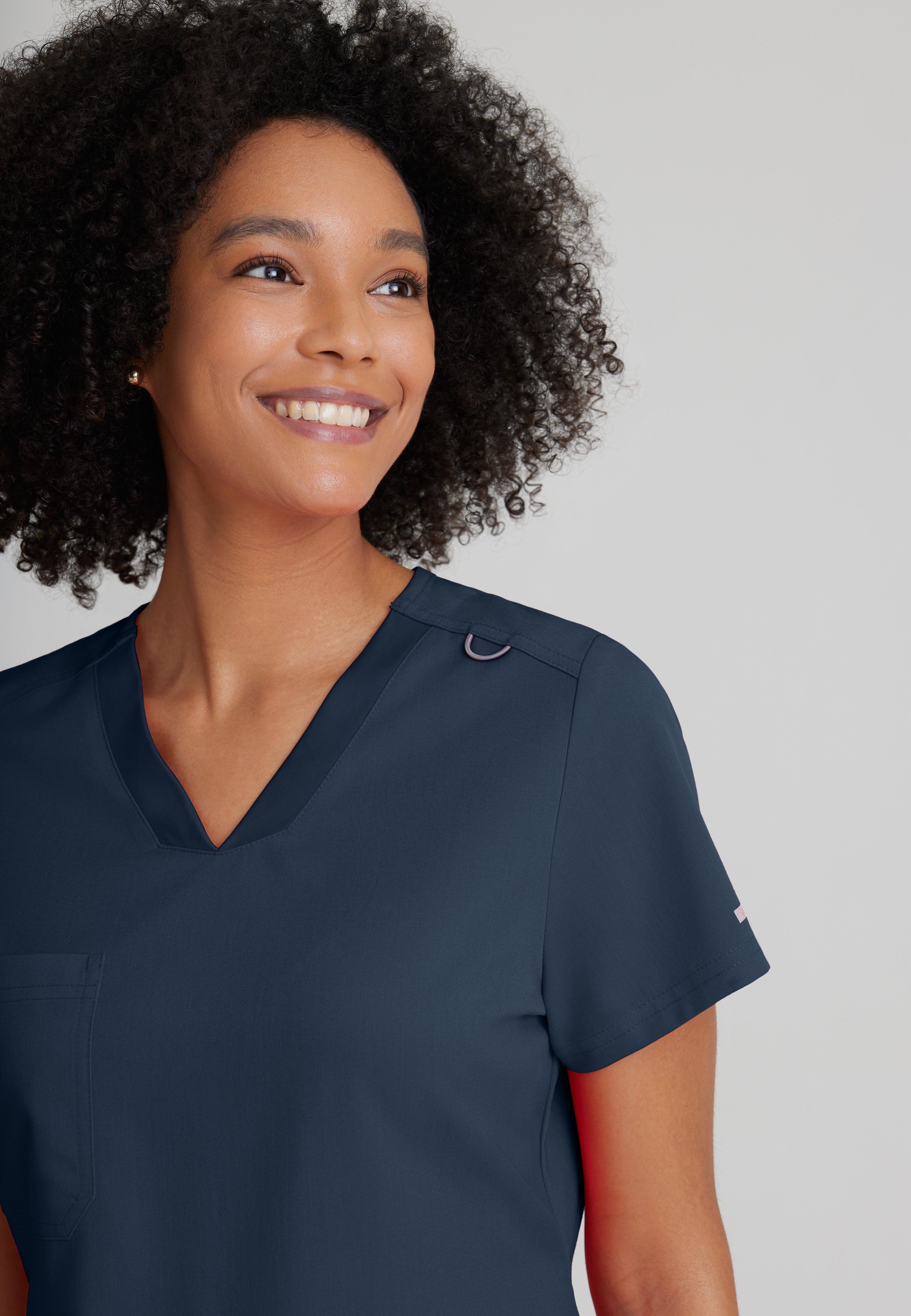 Detail Shot of the Bree 1-Pocket Tuck-In Scrub Top in Steel from Grey's Anatomy™ by Barco Spandex Stretch