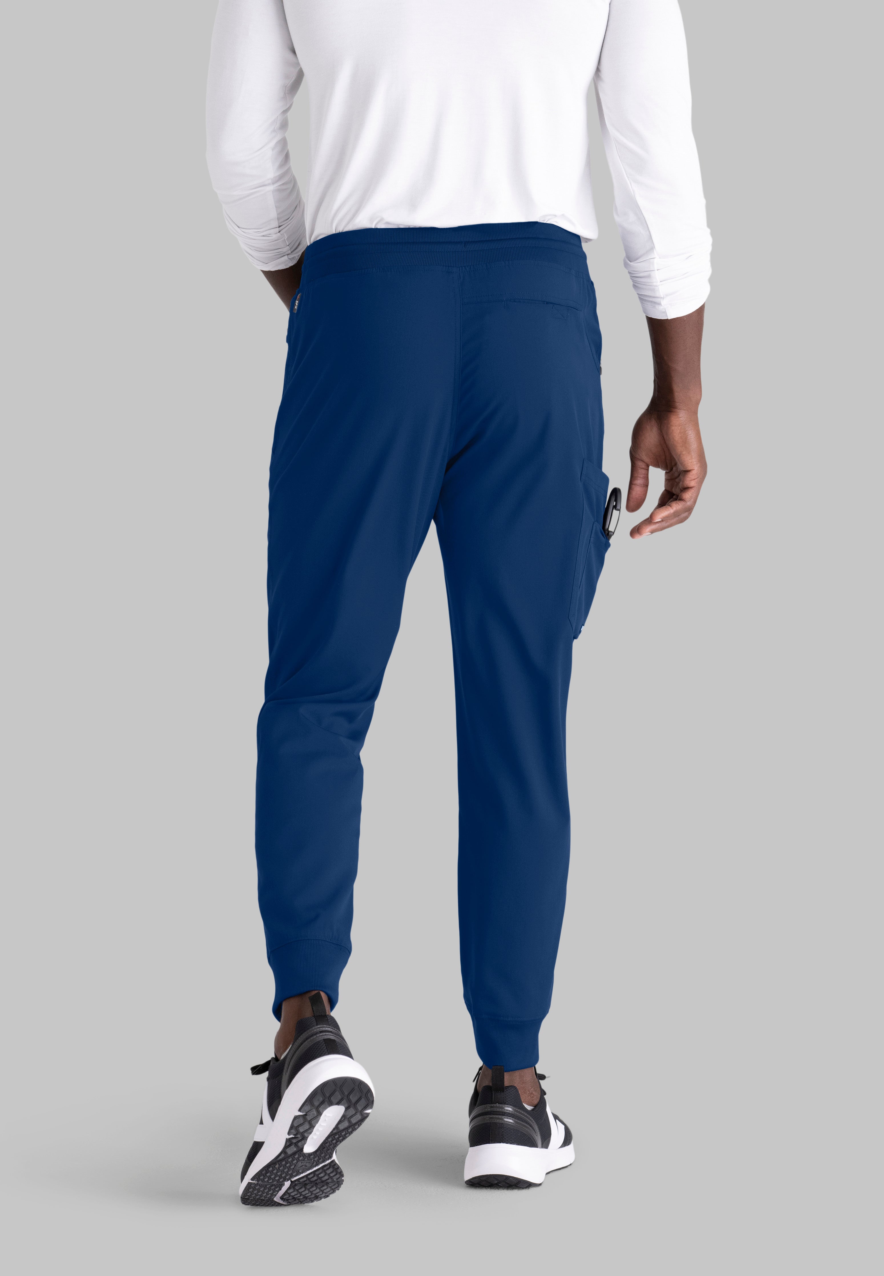 Grey's Anatomy Spandex-Stretch Men’s indigo Zip-Fly 5-Pocket Jogger Scrub Pant. Elastic waistband with drawstring. Wrinkle-resistant, easy care fabric. 