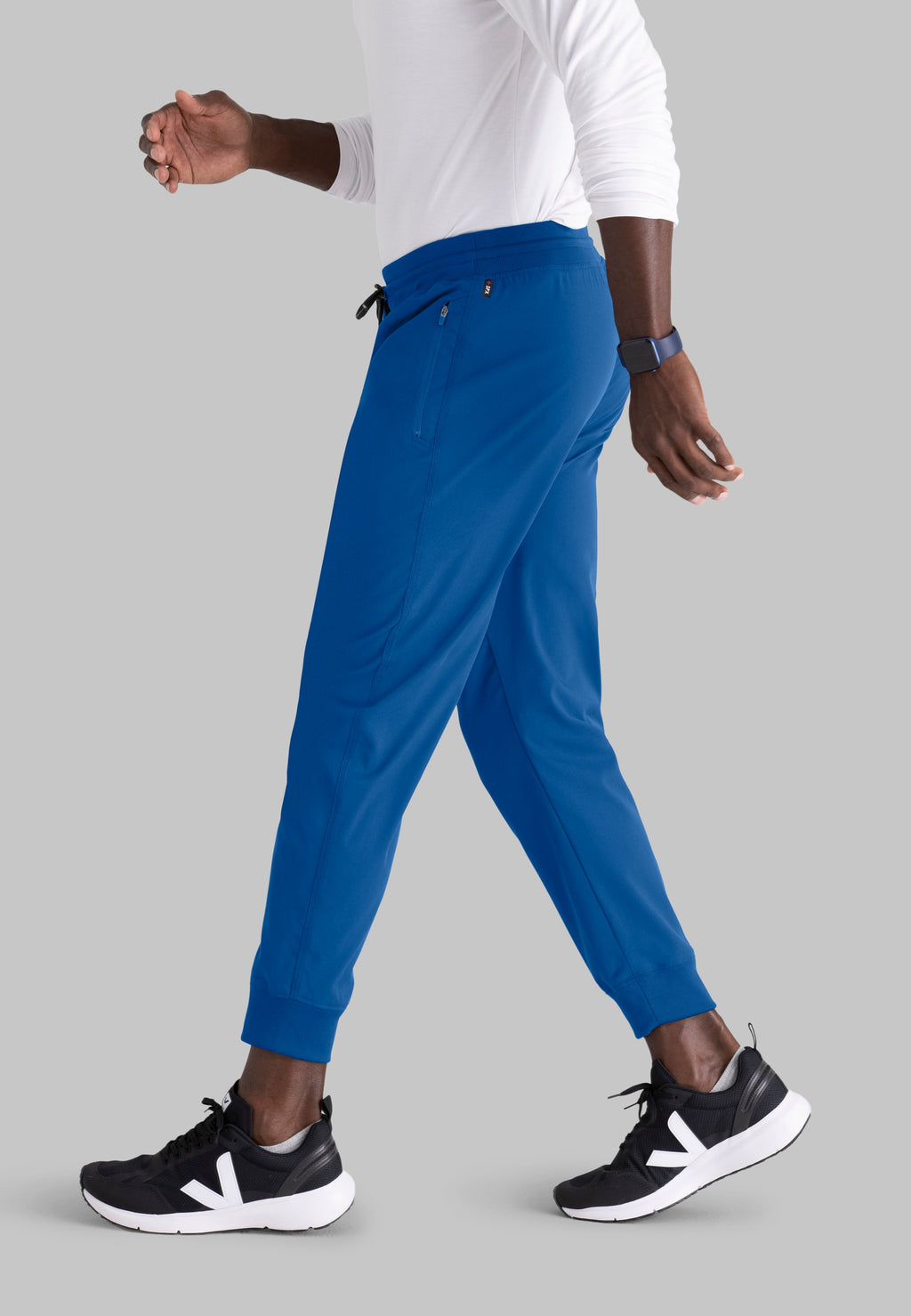 Grey's Anatomy Spandex-Stretch Men’s royal Zip-Fly 5-Pocket Jogger Scrub Pant. Elastic waistband with drawstring. Wrinkle-resistant, easy care fabric. 