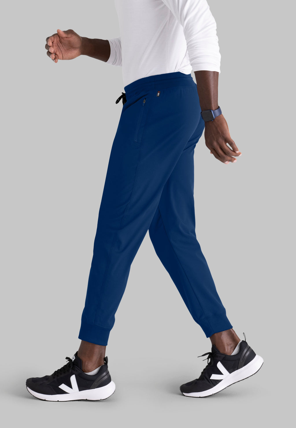 Grey's Anatomy Spandex-Stretch Men’s indigo Zip-Fly 5-Pocket Jogger Scrub Pant. Elastic waistband with drawstring. Wrinkle-resistant, easy care fabric. 