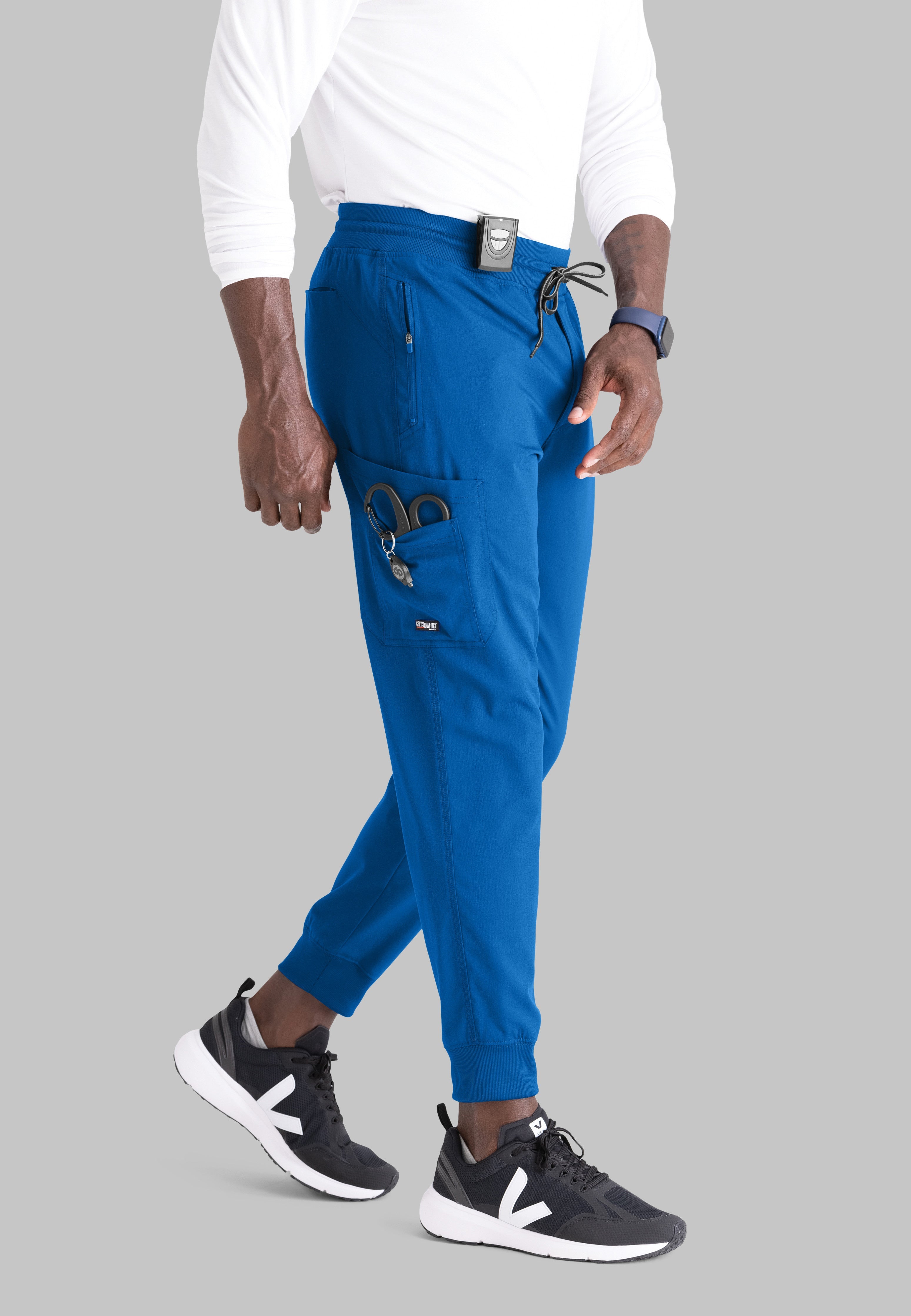 Grey's Anatomy Spandex-Stretch Men’s royal Zip-Fly 5-Pocket Jogger Scrub Pant. Elastic waistband with drawstring. Wrinkle-resistant, easy care fabric. 