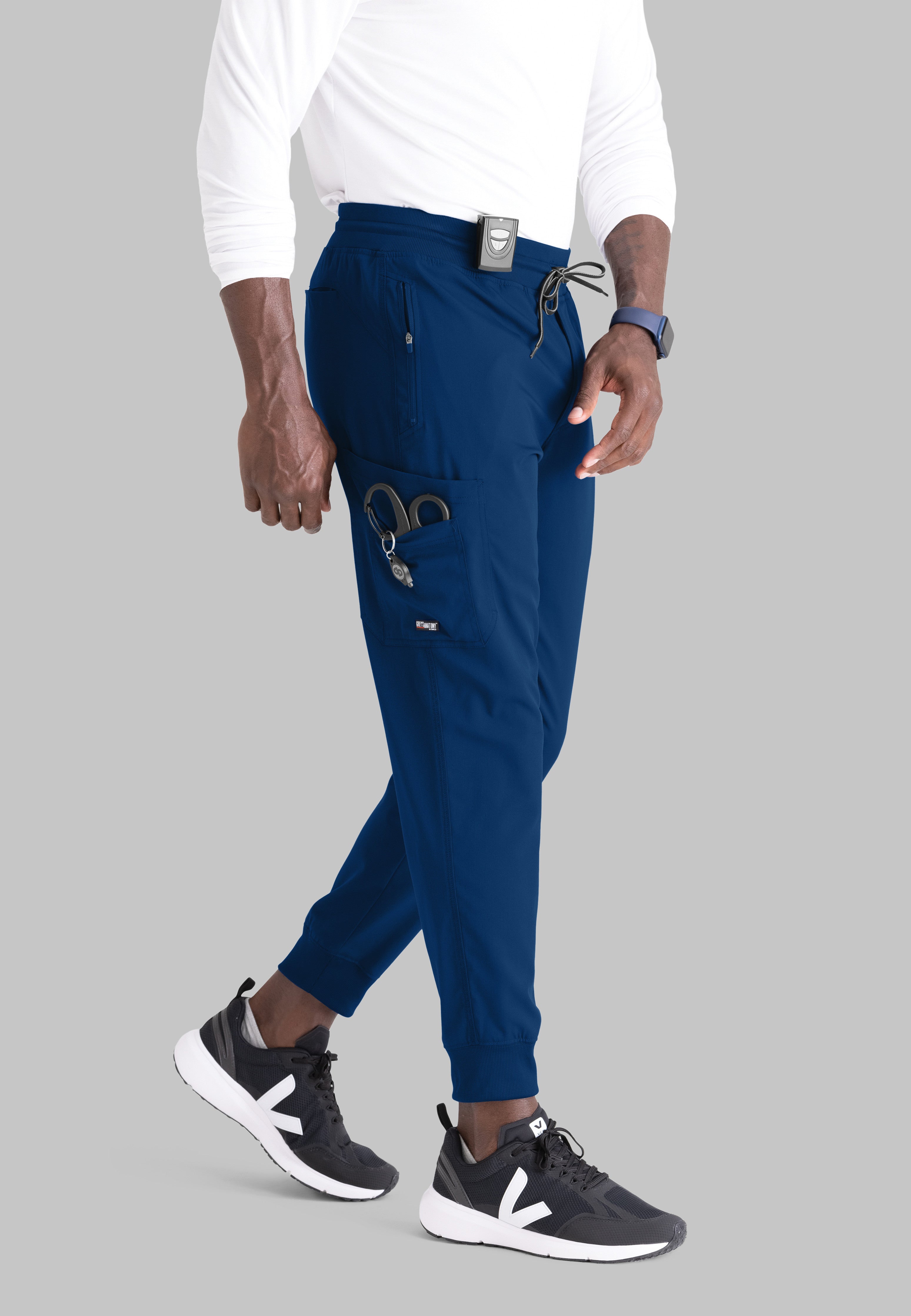 Grey's Anatomy Spandex-Stretch Men’s indigo Zip-Fly 5-Pocket Jogger Scrub Pant. Elastic waistband with drawstring. Wrinkle-resistant, easy care fabric. 